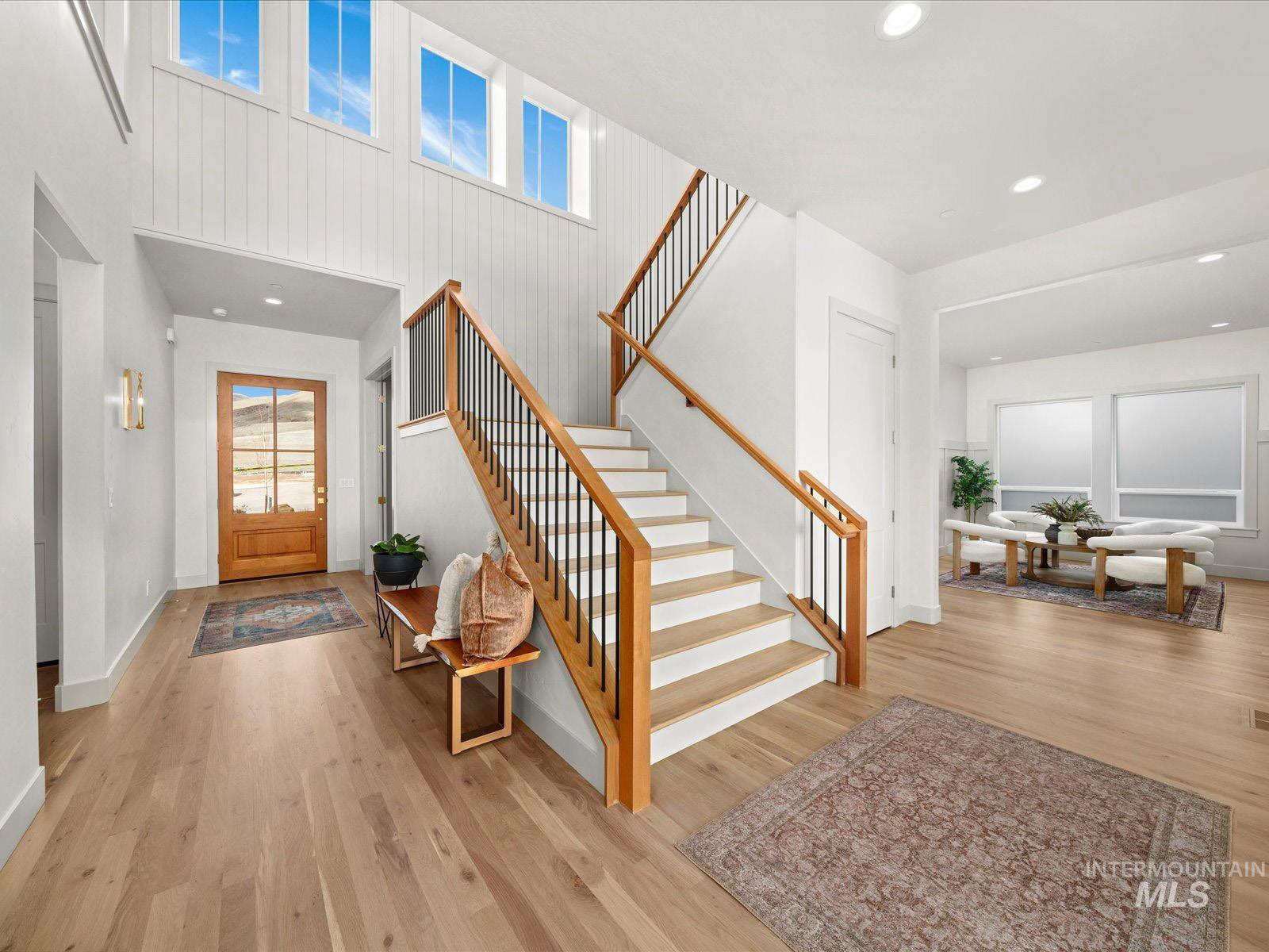 Foyer with recessed lighting, light wood-style floors, and a high ceiling
