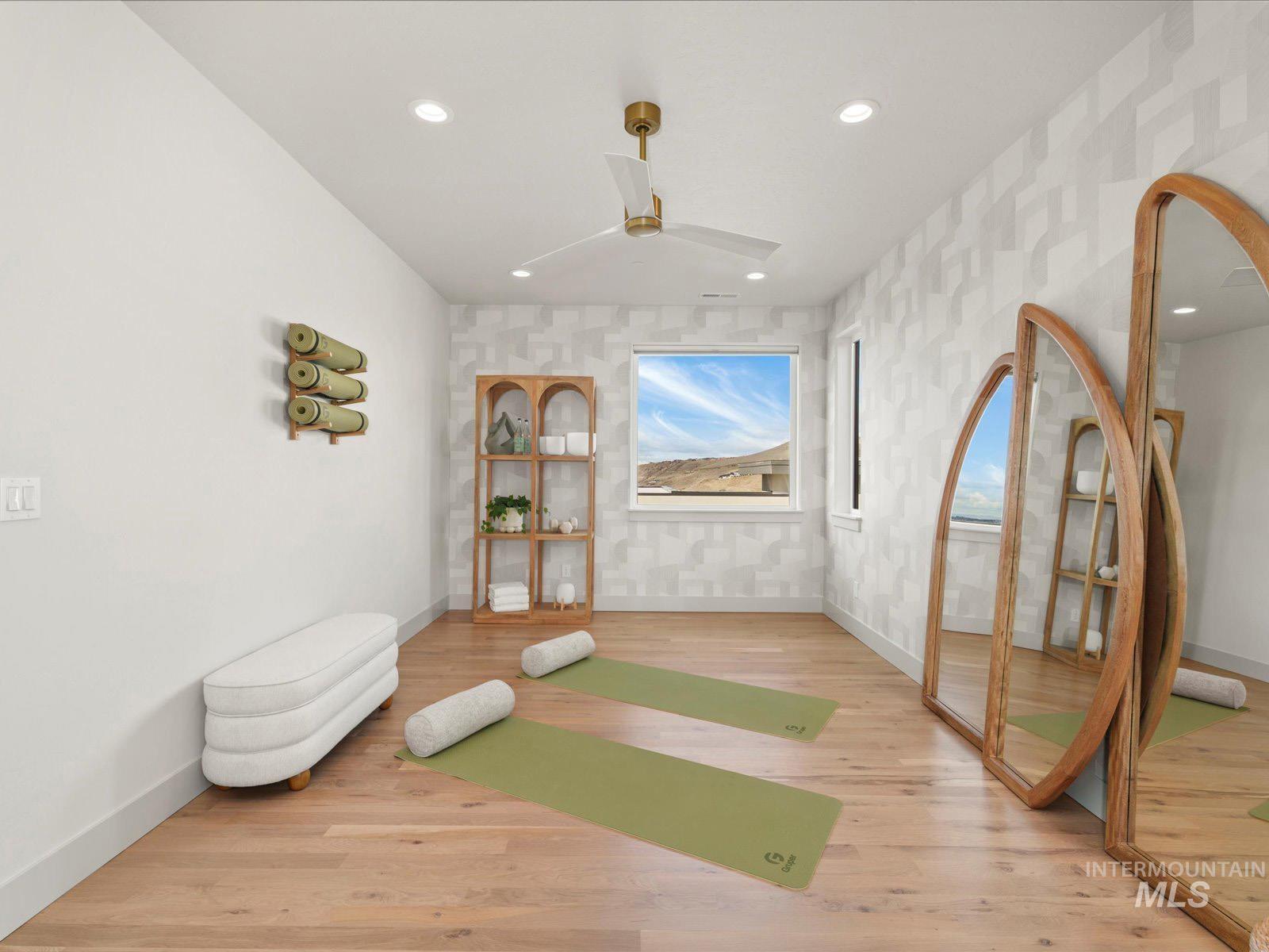 Exercise area featuring wood finished floors, recessed lighting, a ceiling fan, and wallpapered walls