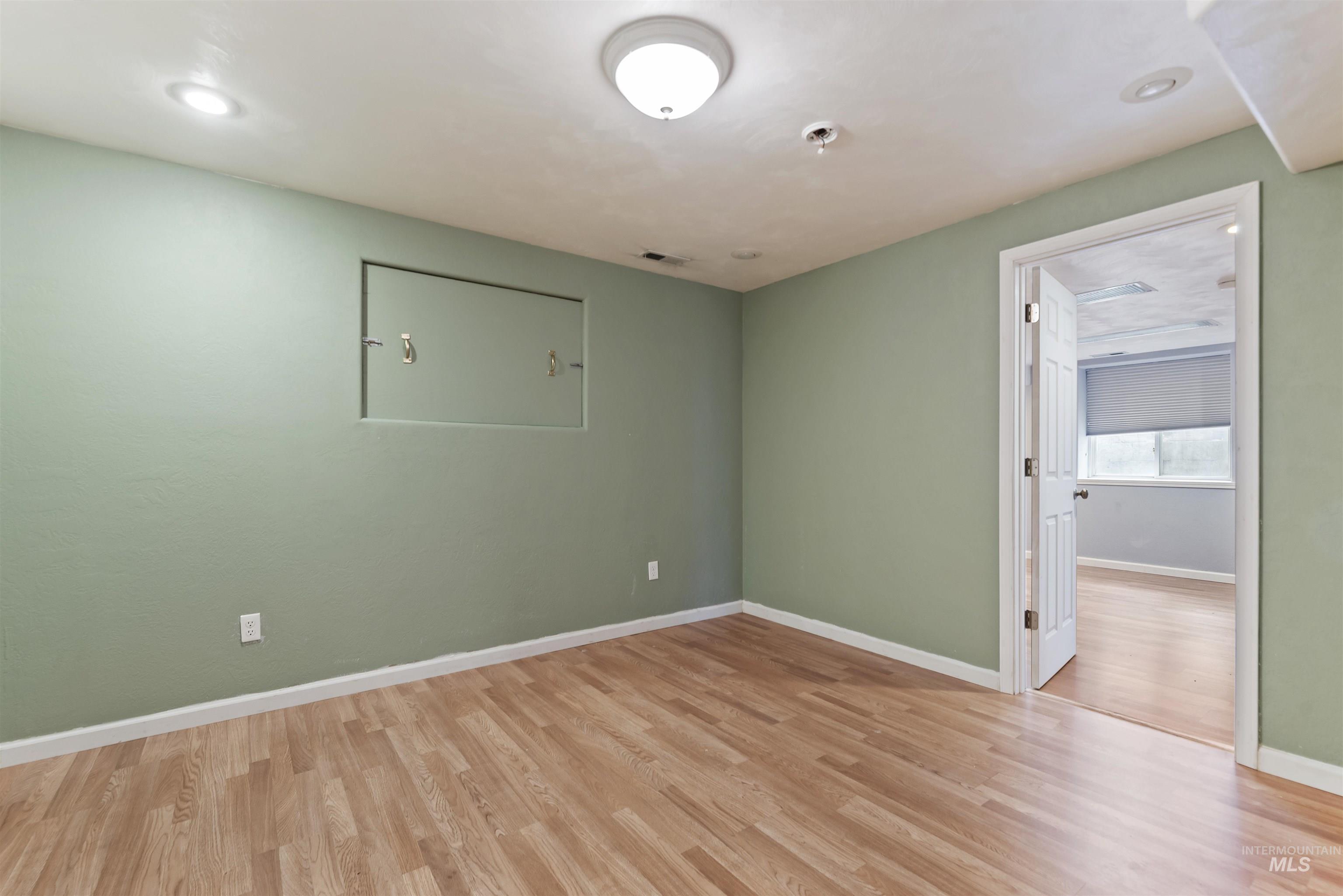 Unfurnished room with light wood-style flooring and recessed lighting