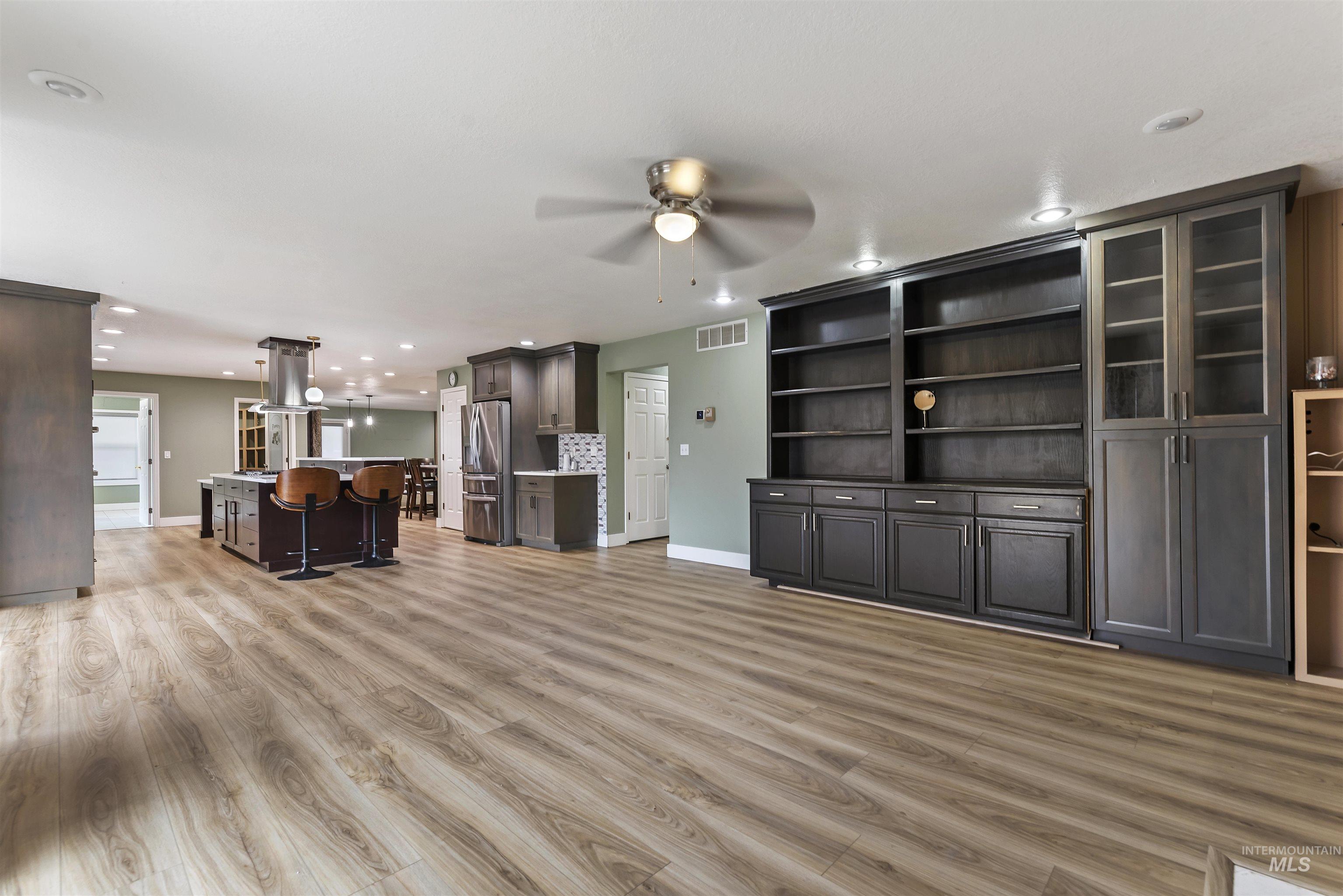 Unfurnished living room featuring light wood finished floors, recessed lighting, and ceiling fan