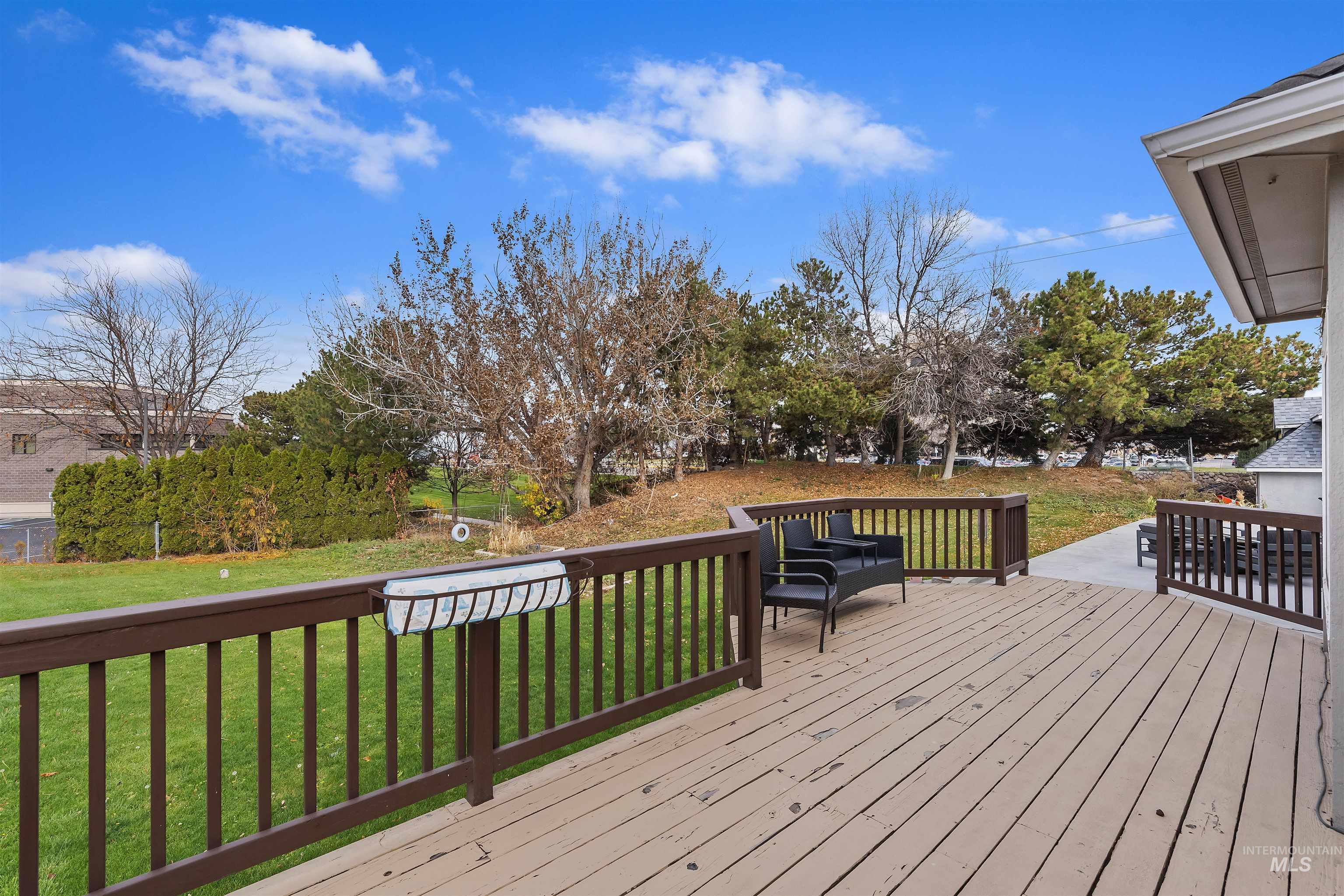 Wooden terrace featuring a lawn