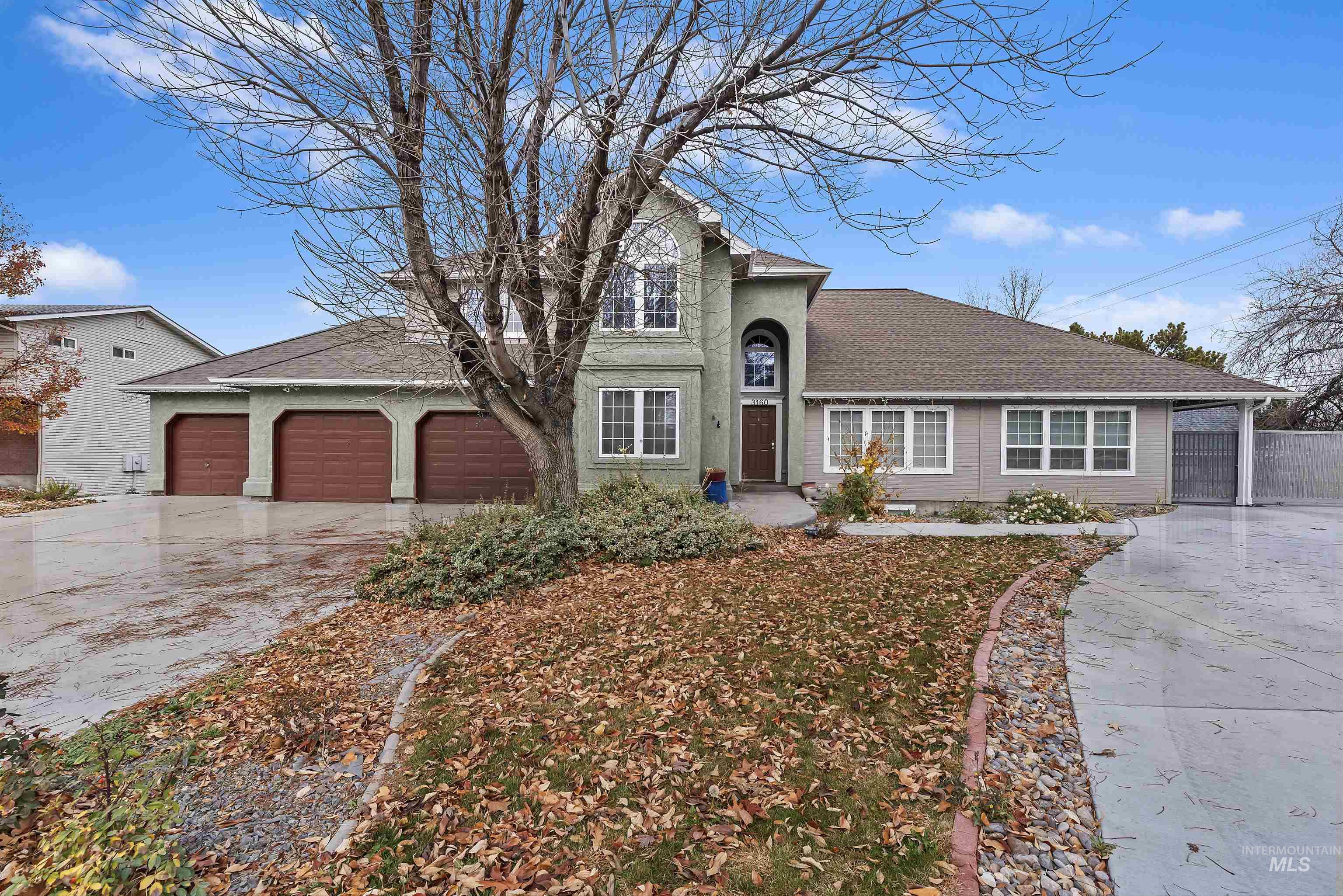 Traditional-style house featuring driveway, an attached garage, and roof with shingles
