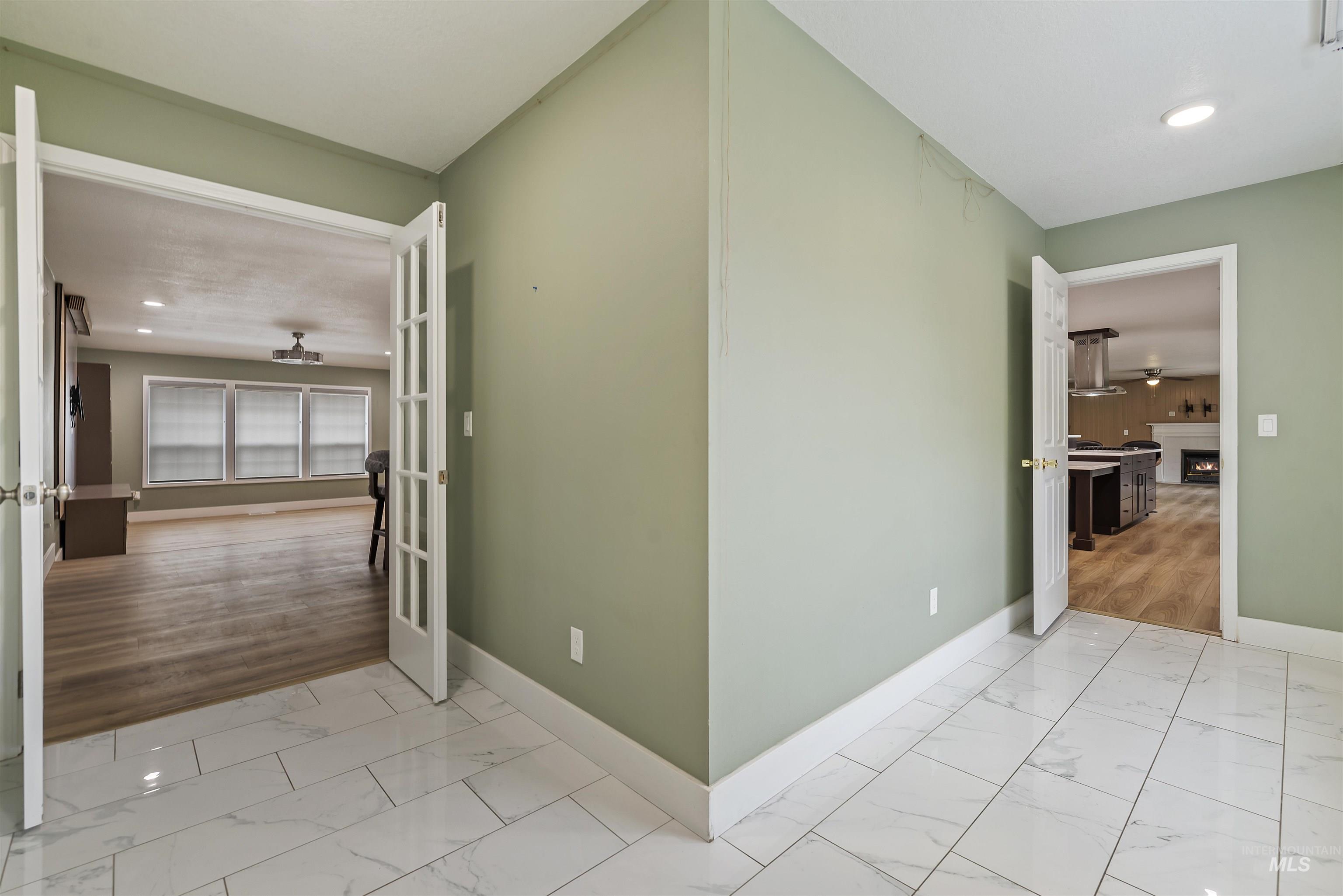 Hall with recessed lighting and light marble finish floors