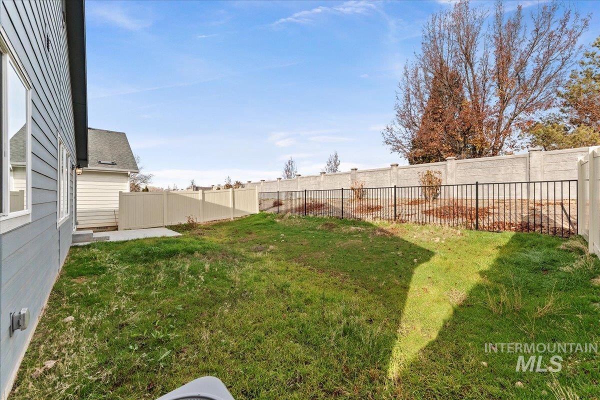 Fenced backyard featuring a patio
