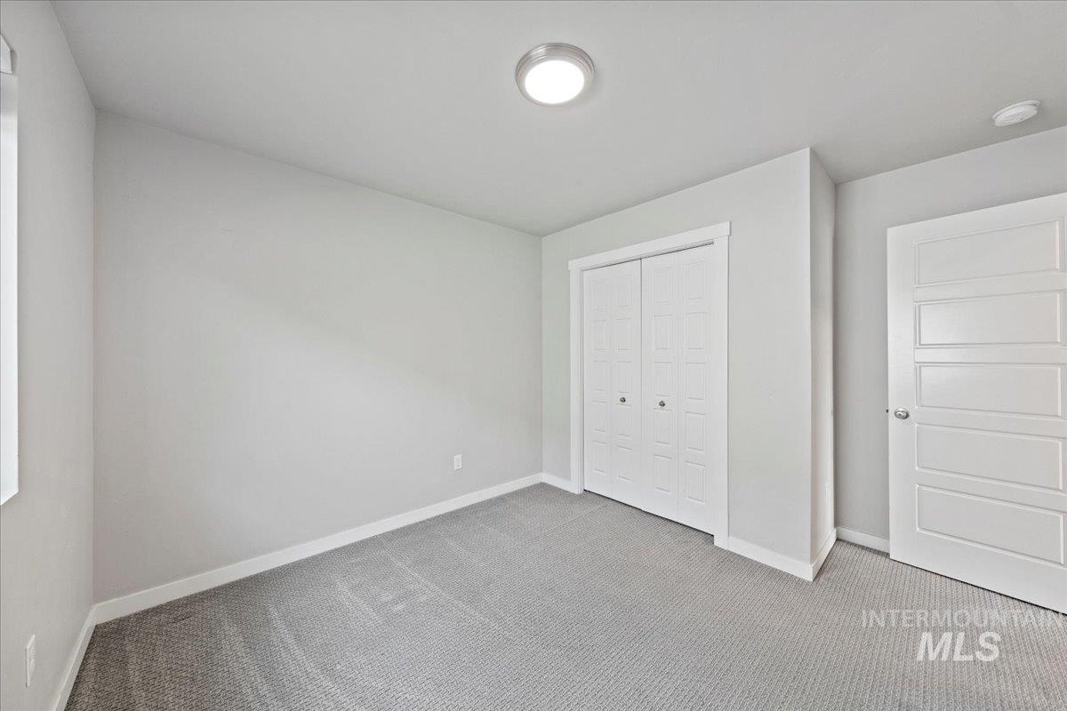 Unfurnished bedroom with carpet flooring and a closet