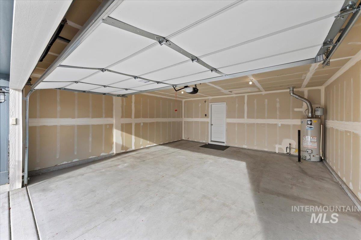 Garage featuring gas water heater