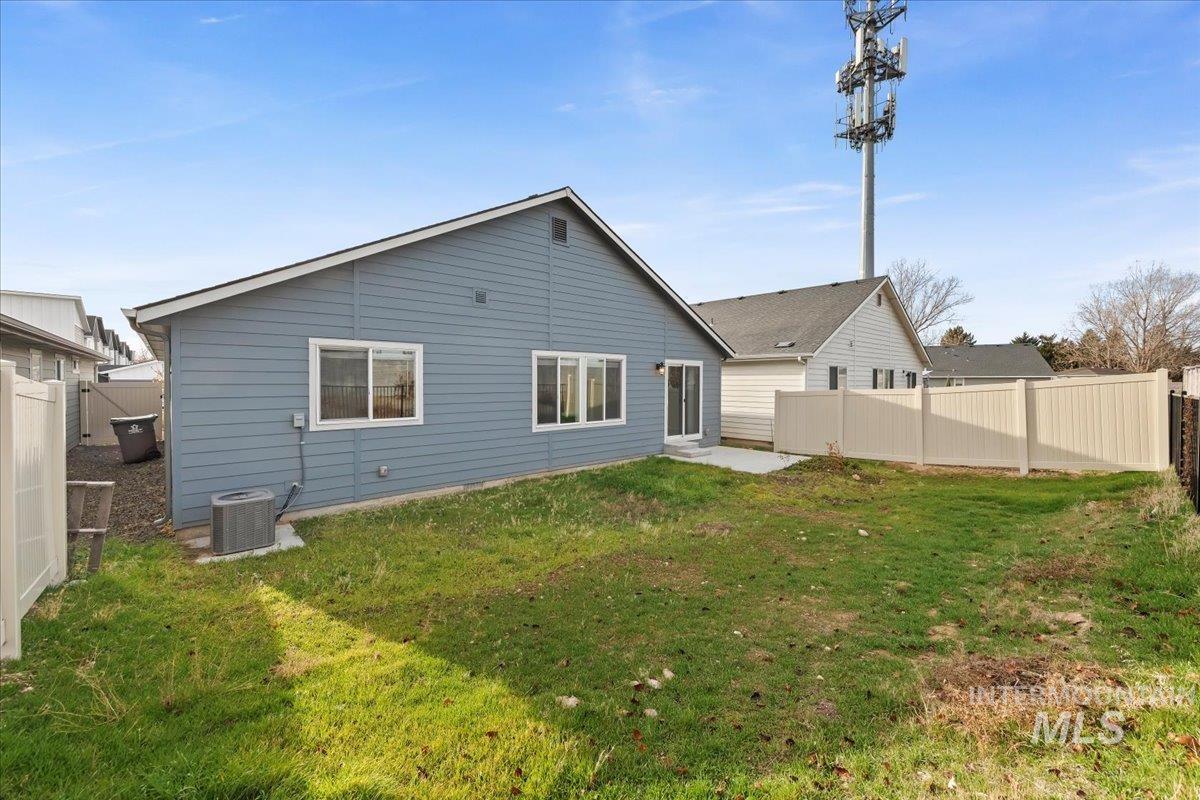 Rear view of house featuring a patio area and a fenced backyard
