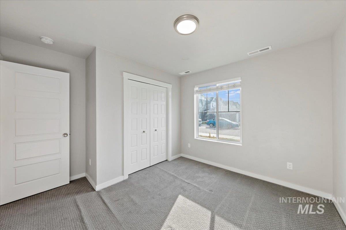 Unfurnished bedroom with carpet flooring and a closet