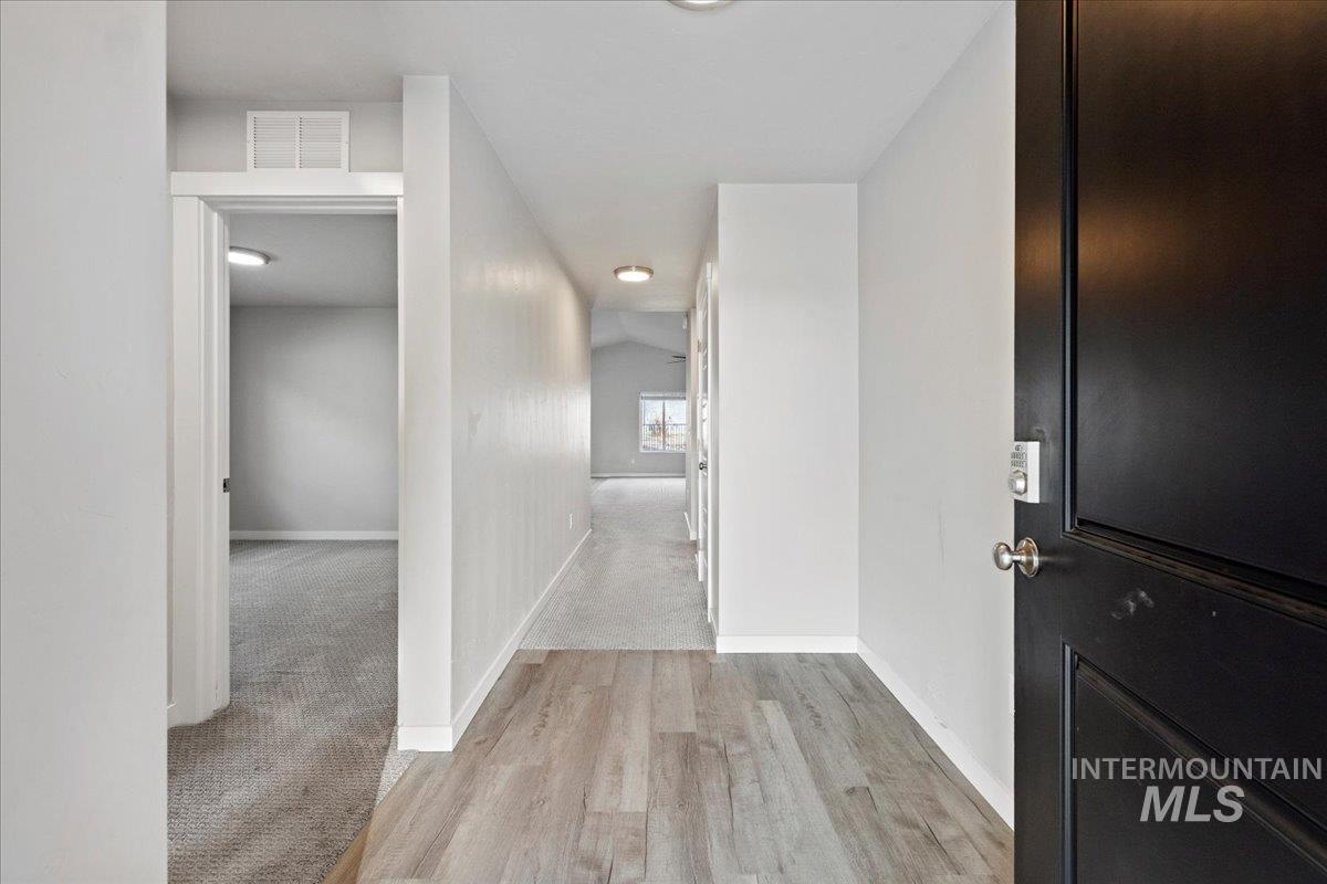 Hall featuring baseboards and light wood-type flooring