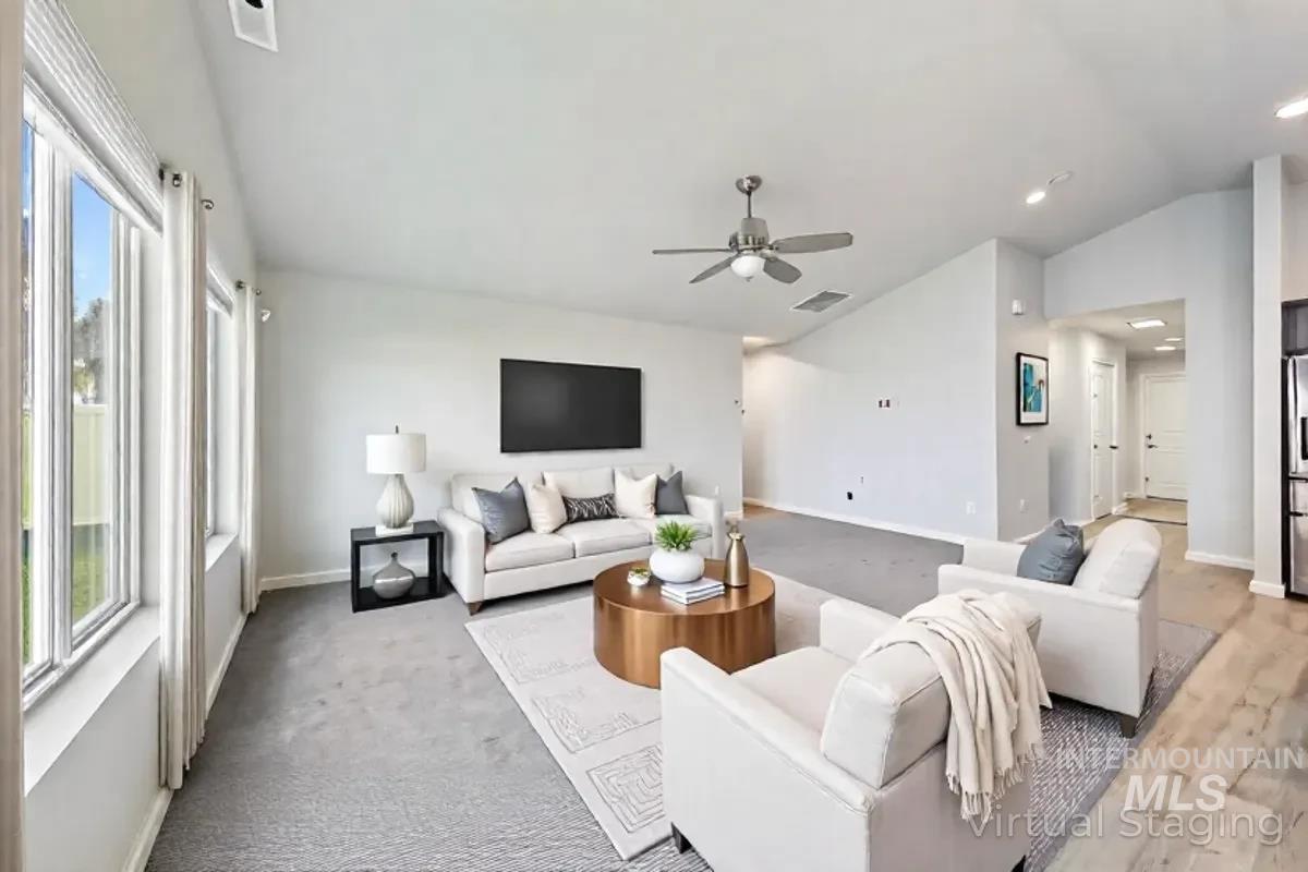 Living room featuring lofted ceiling and a ceiling fan