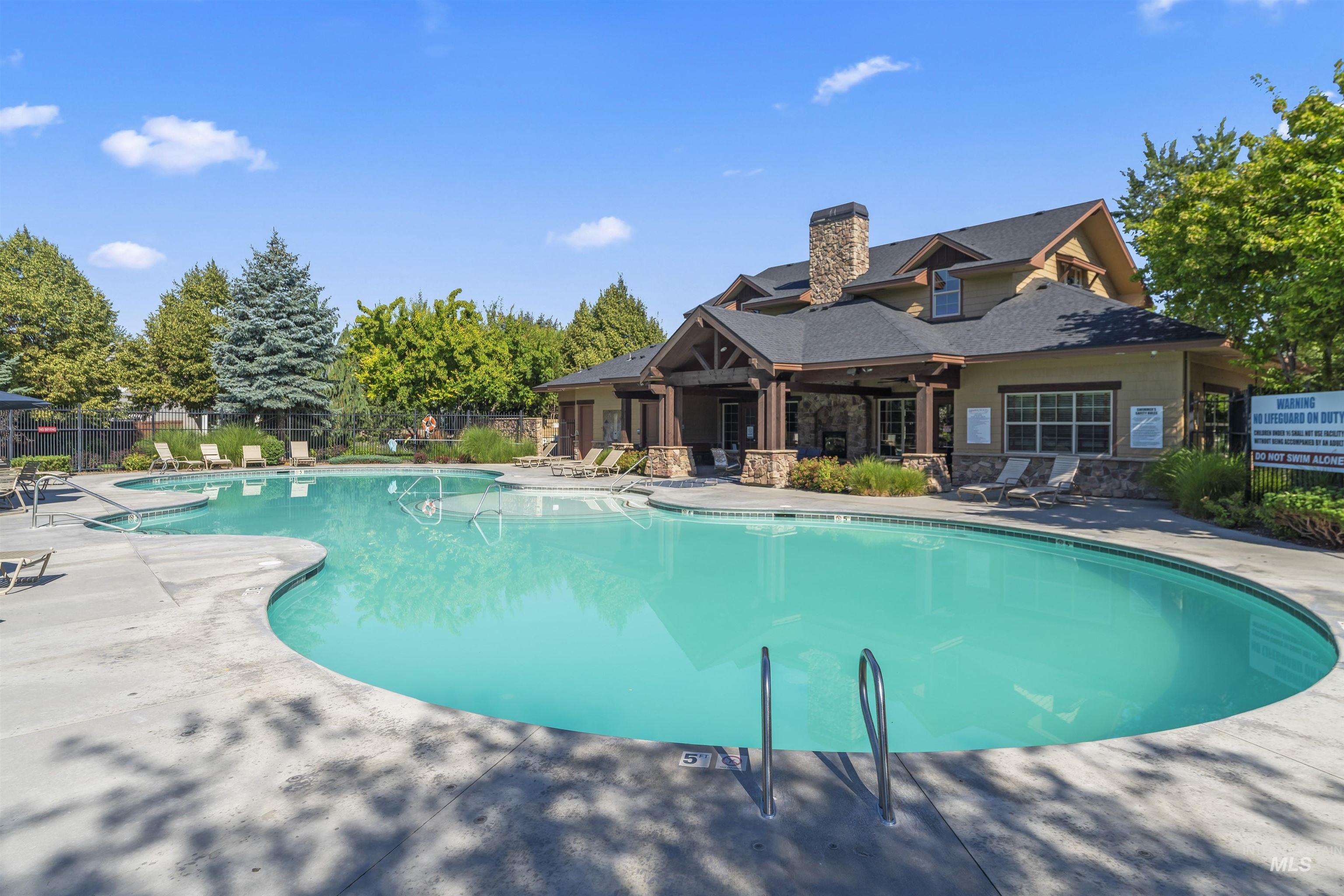 Community saltwaterpool with a patio area and club house.
