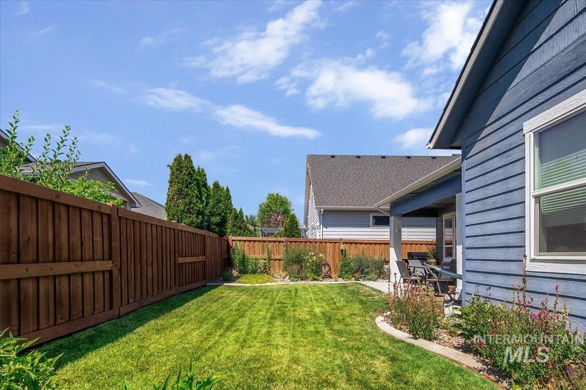 Fenced backyard with a patio
