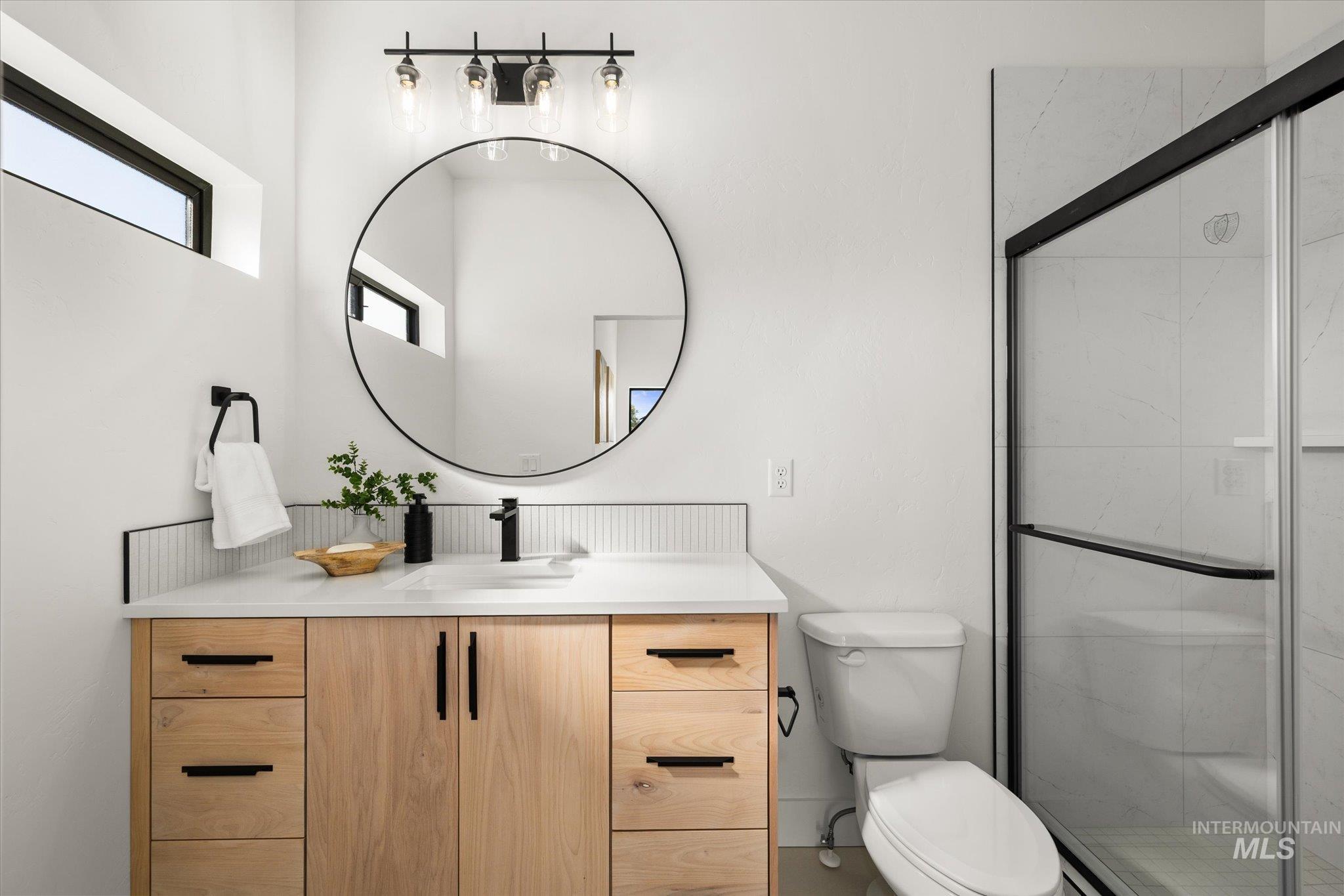 Full bathroom featuring vanity and a marble finish shower