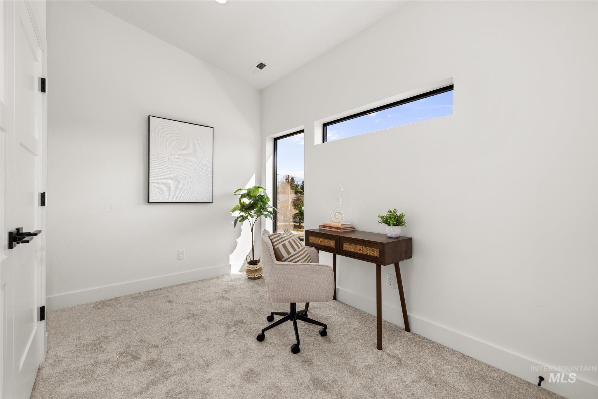 Carpeted home office with baseboards