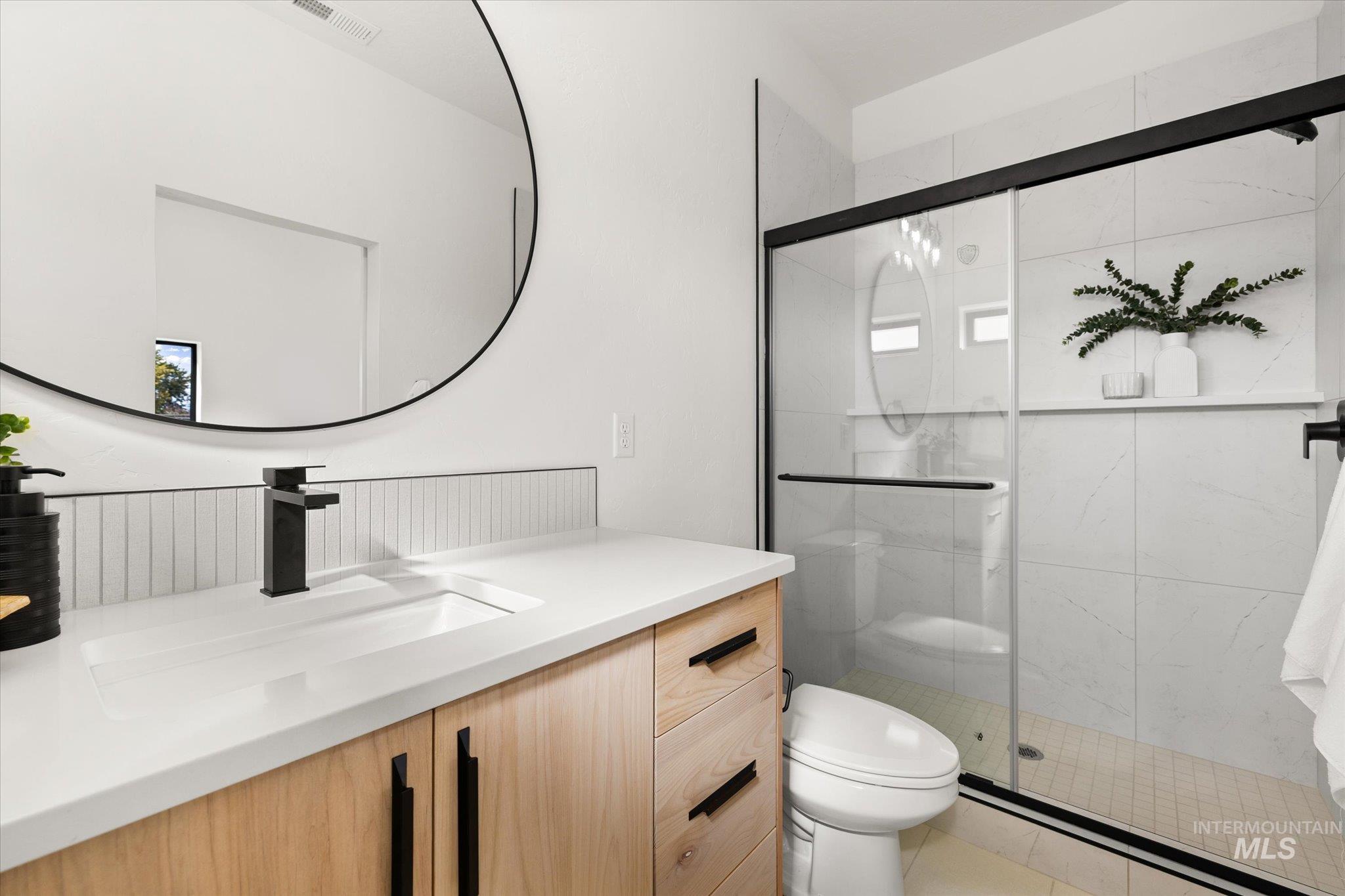 Bathroom with vanity and a shower stall