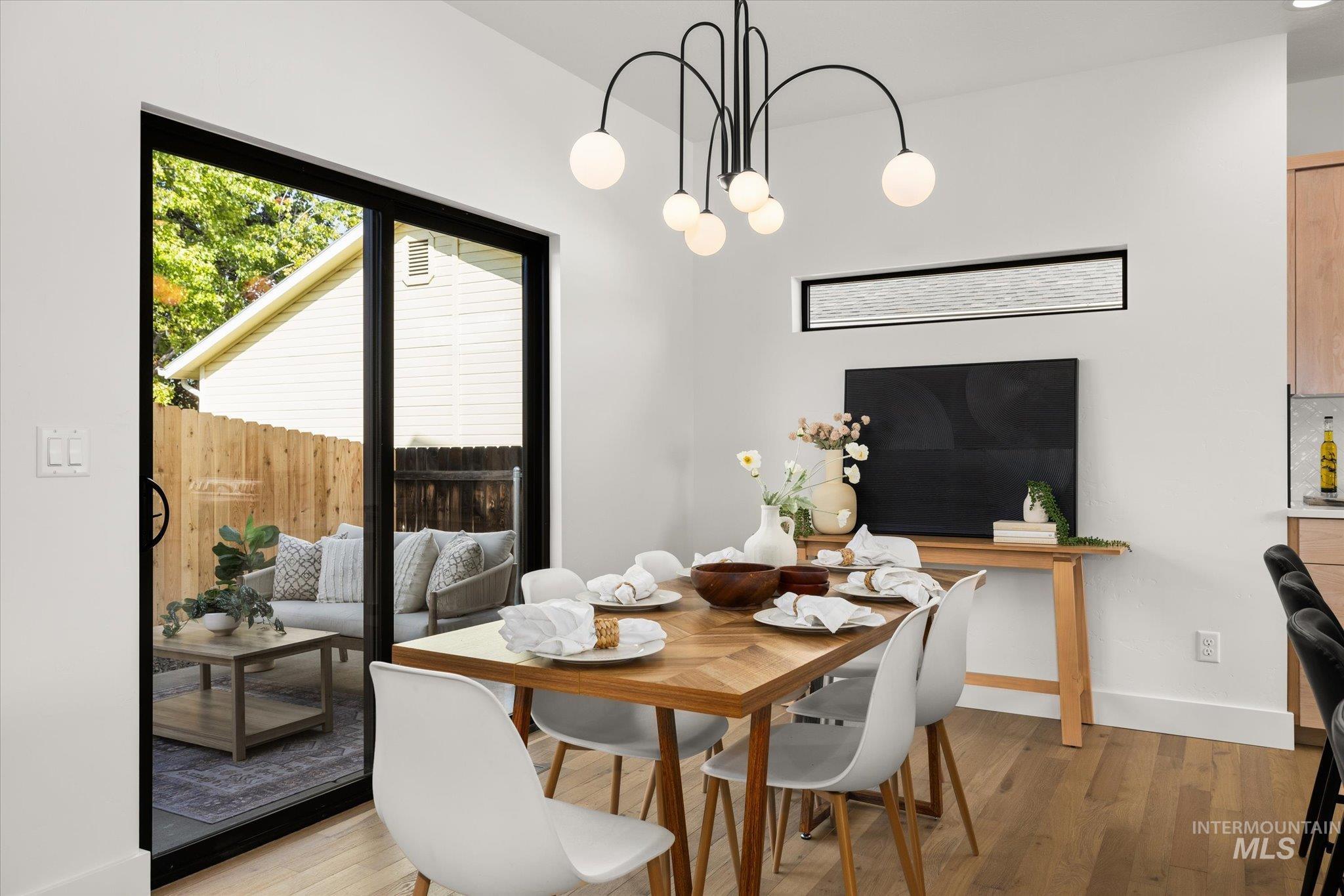 Dining area featuring light wood-type flooring and a chandelier