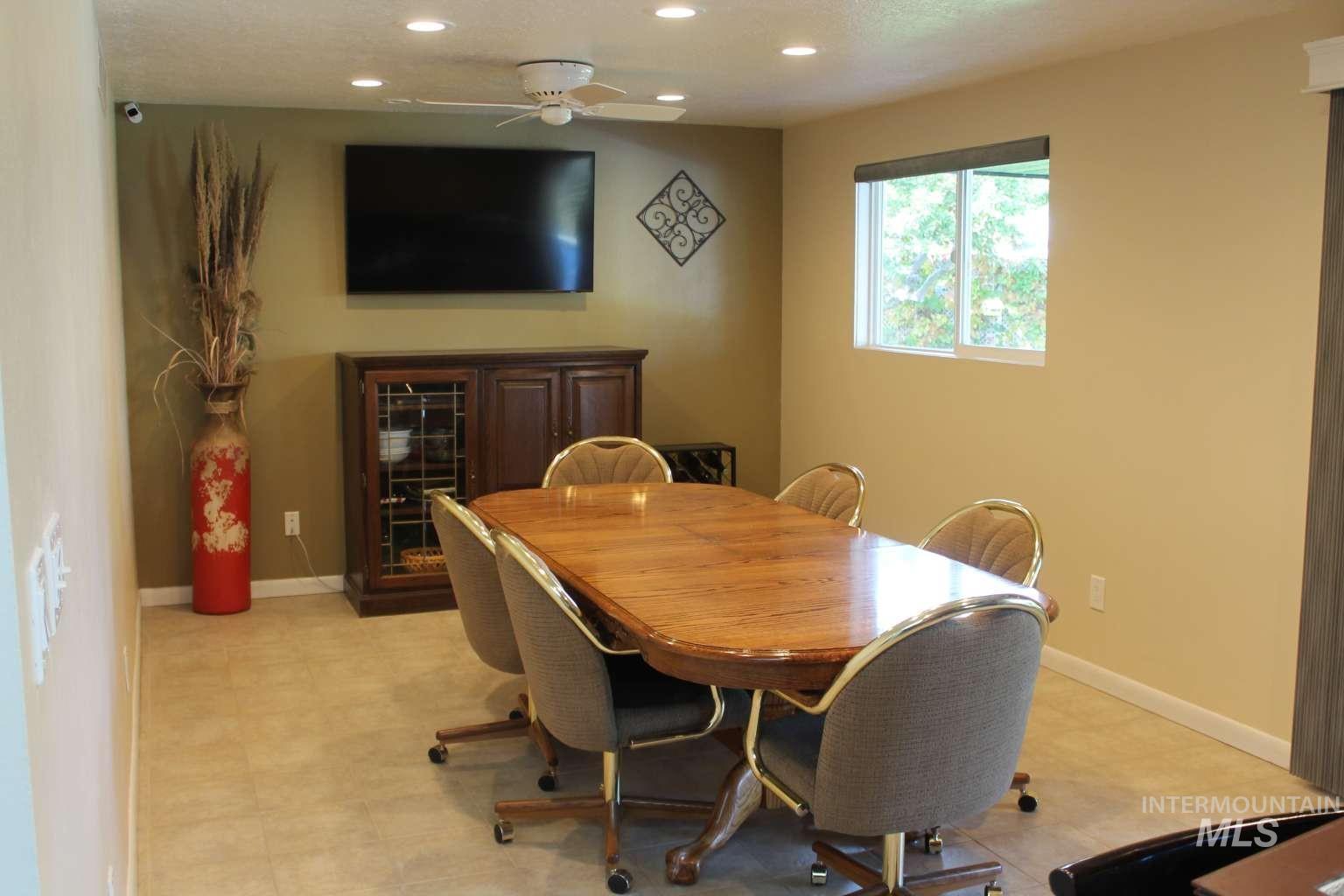 Dining space with recessed lighting and ceiling fan