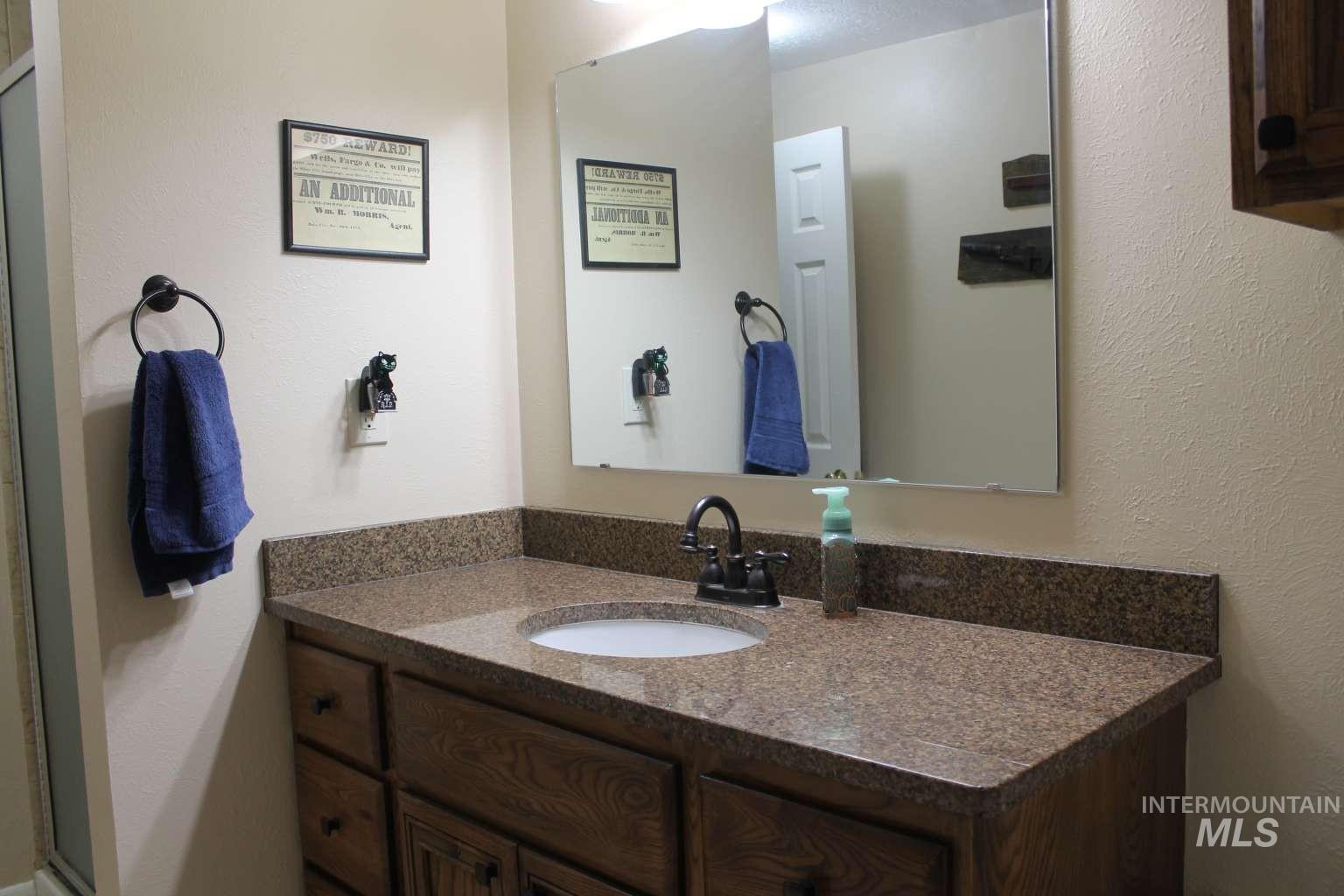 Bathroom featuring vanity and a textured wall
