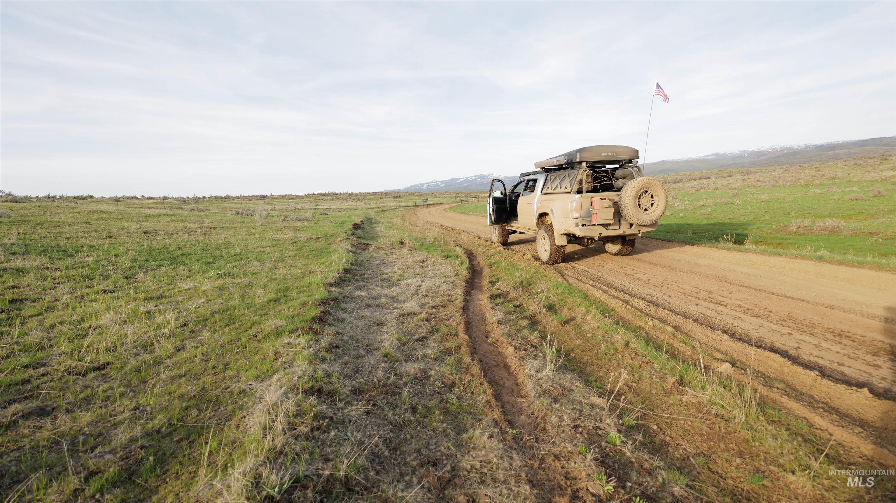 View of dirt / gravel road with a view of countryside