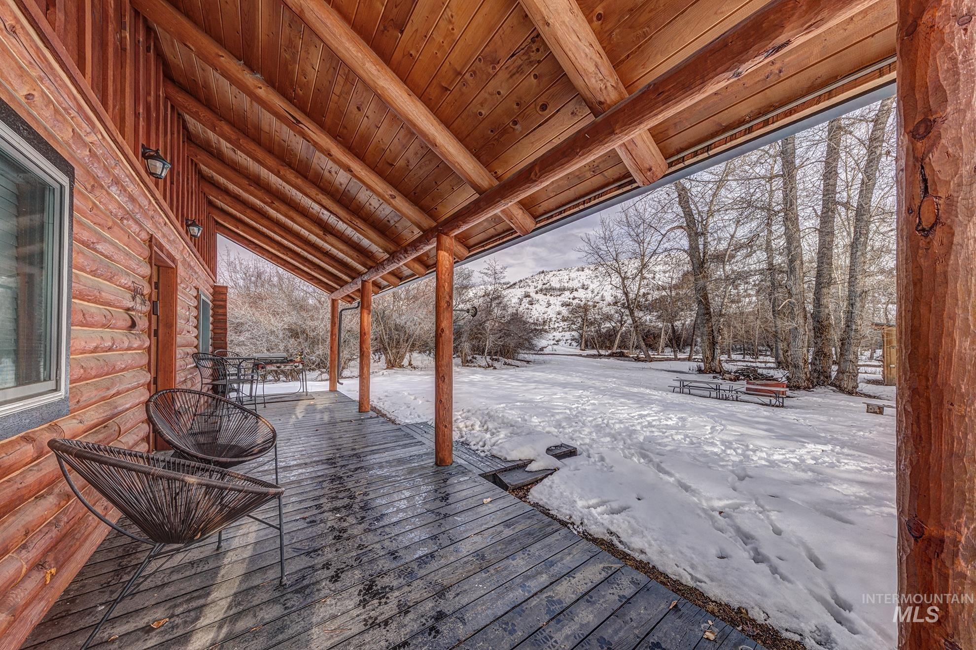 Snow covered deck featuring a mountain view