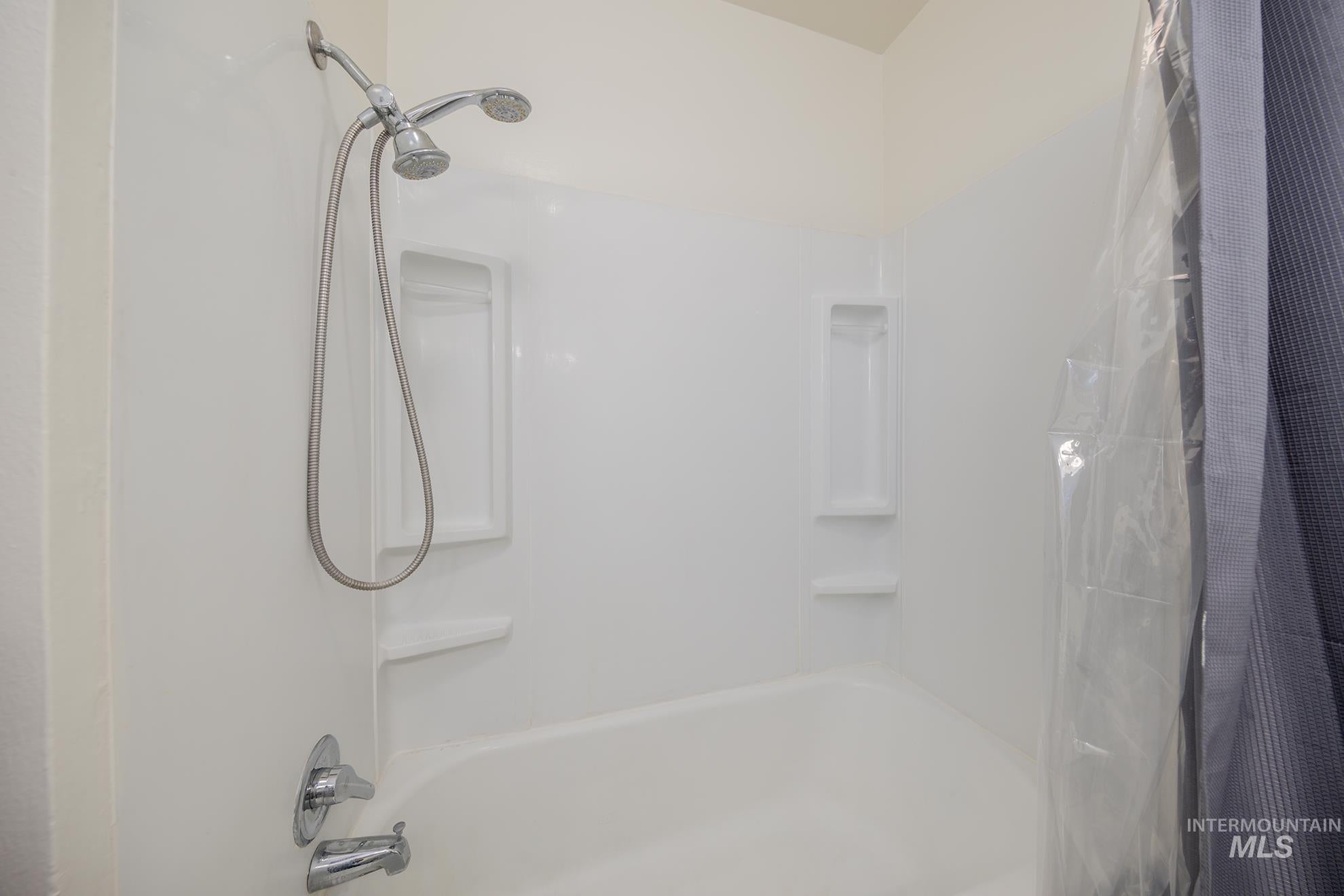Full bath featuring shower / tub combo