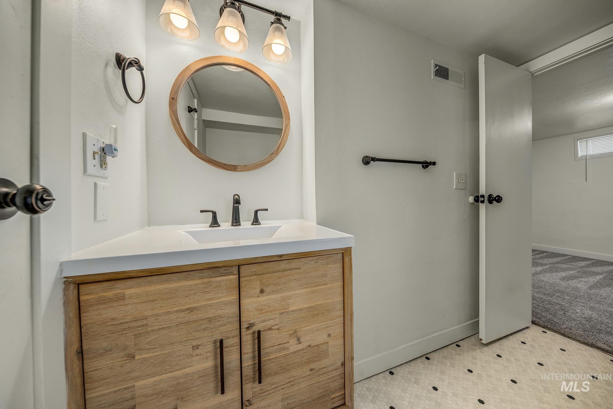 Bathroom with vanity and baseboards
