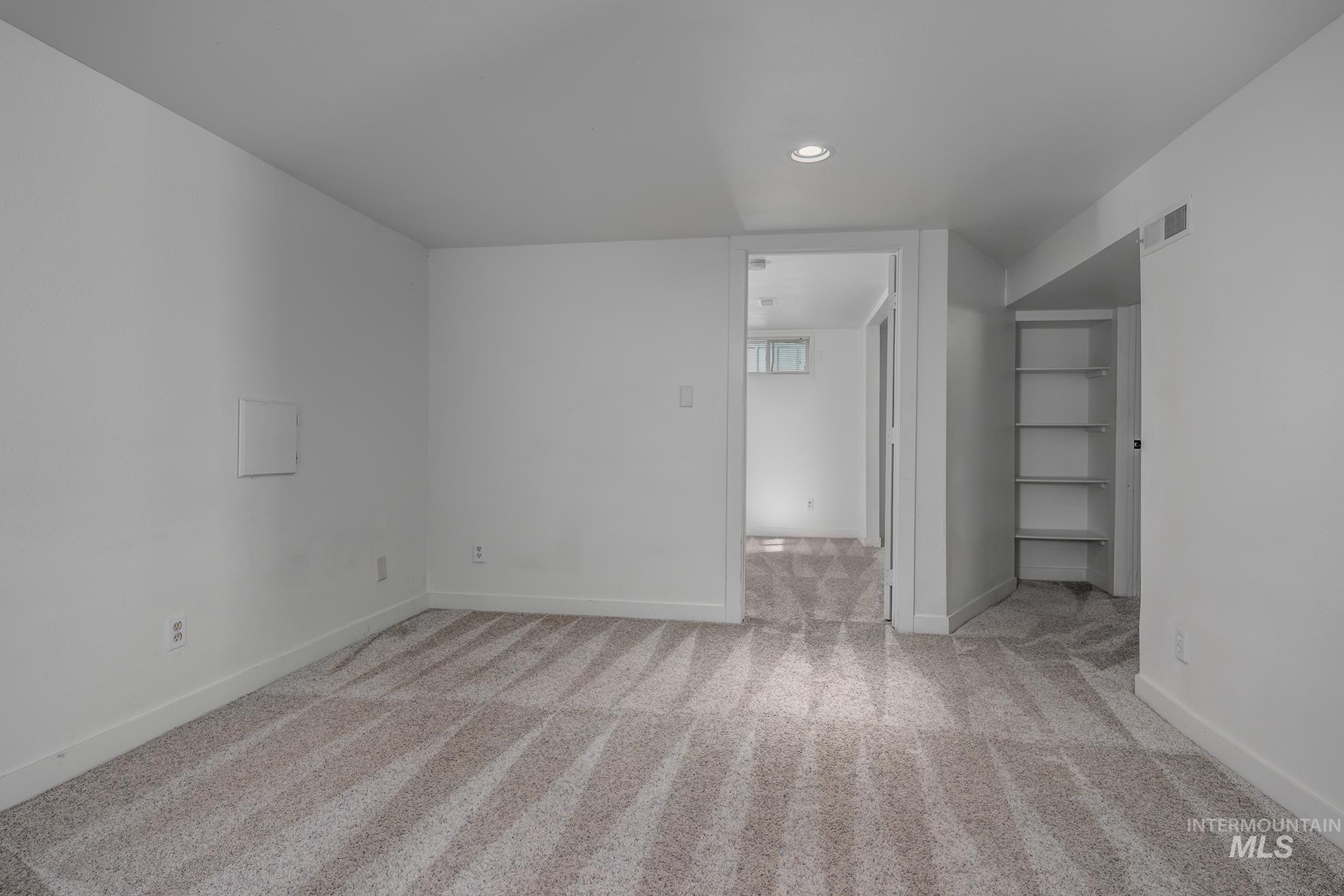Spare room with light carpet and recessed lighting