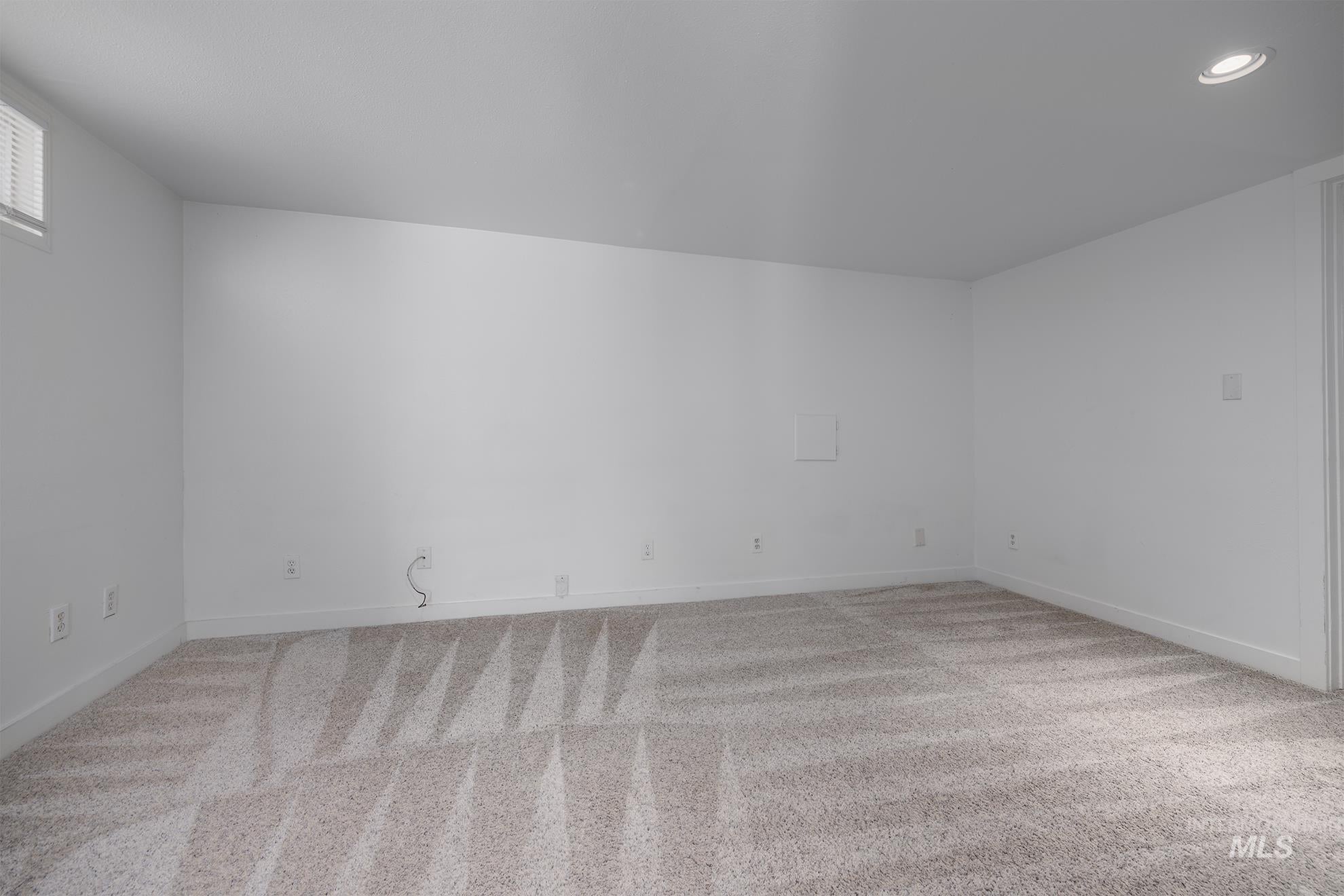 Additional living space with light colored carpet and recessed lighting