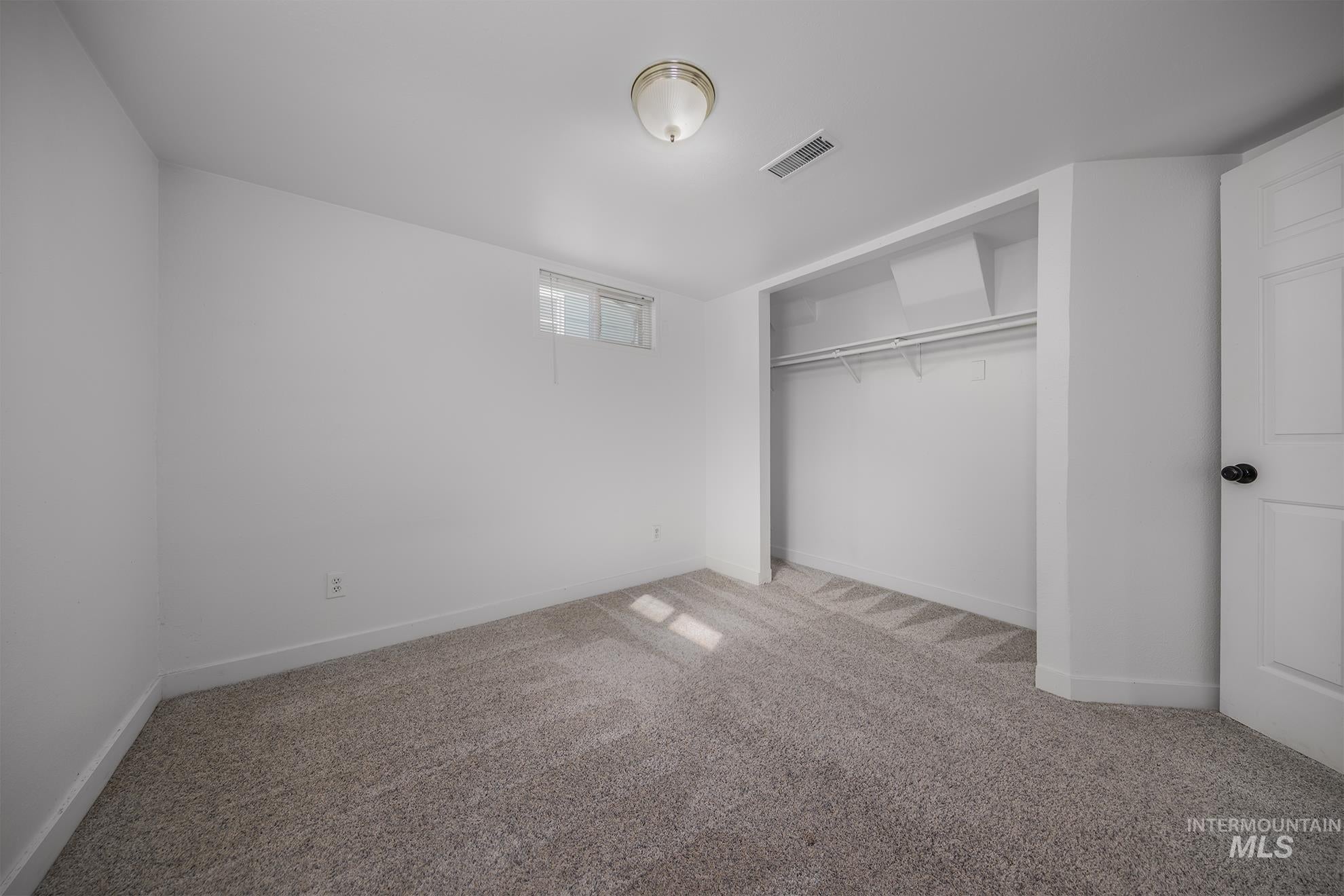 Unfurnished bedroom with carpet floors and a closet