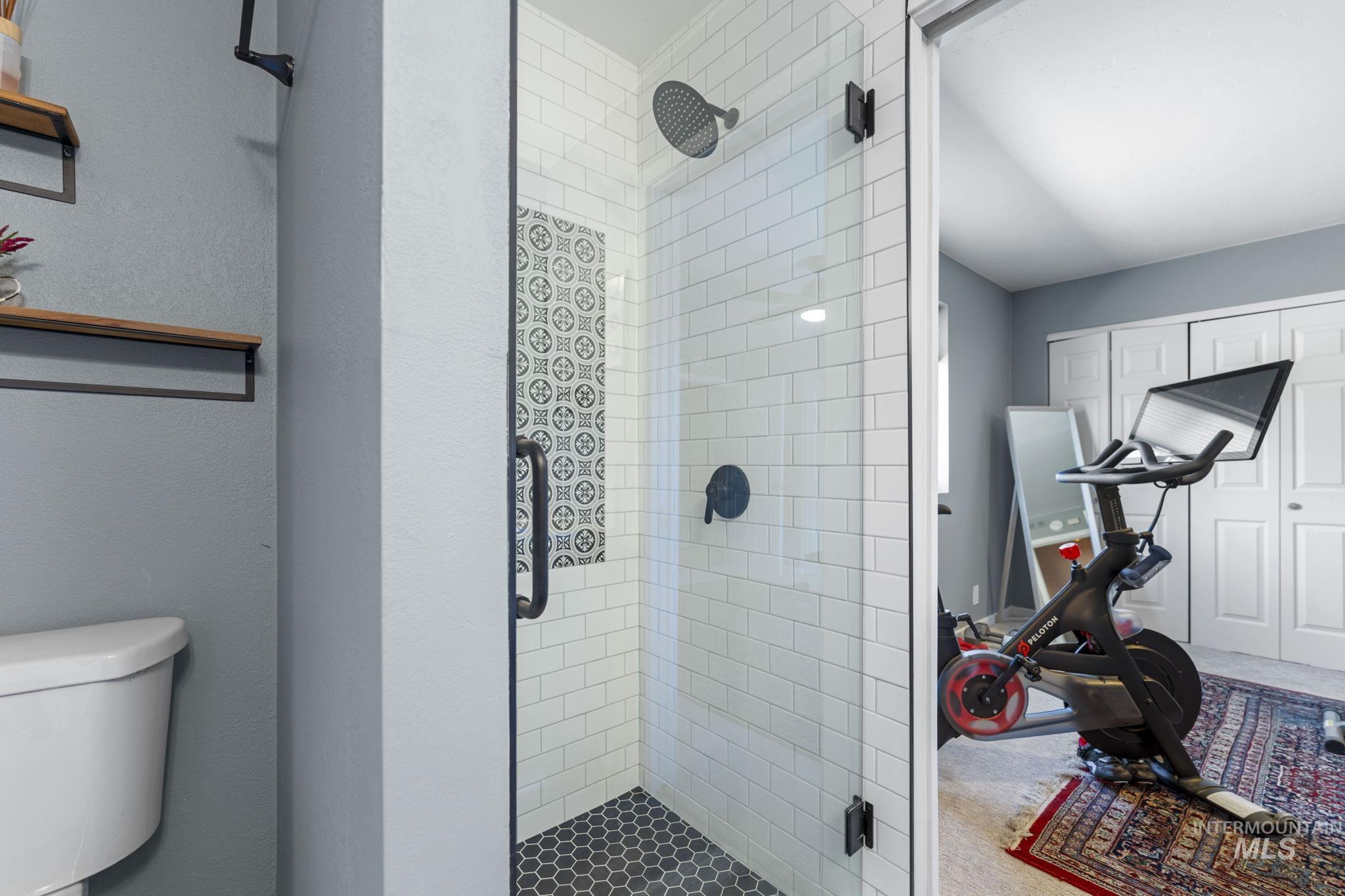 Full bathroom featuring a shower stall