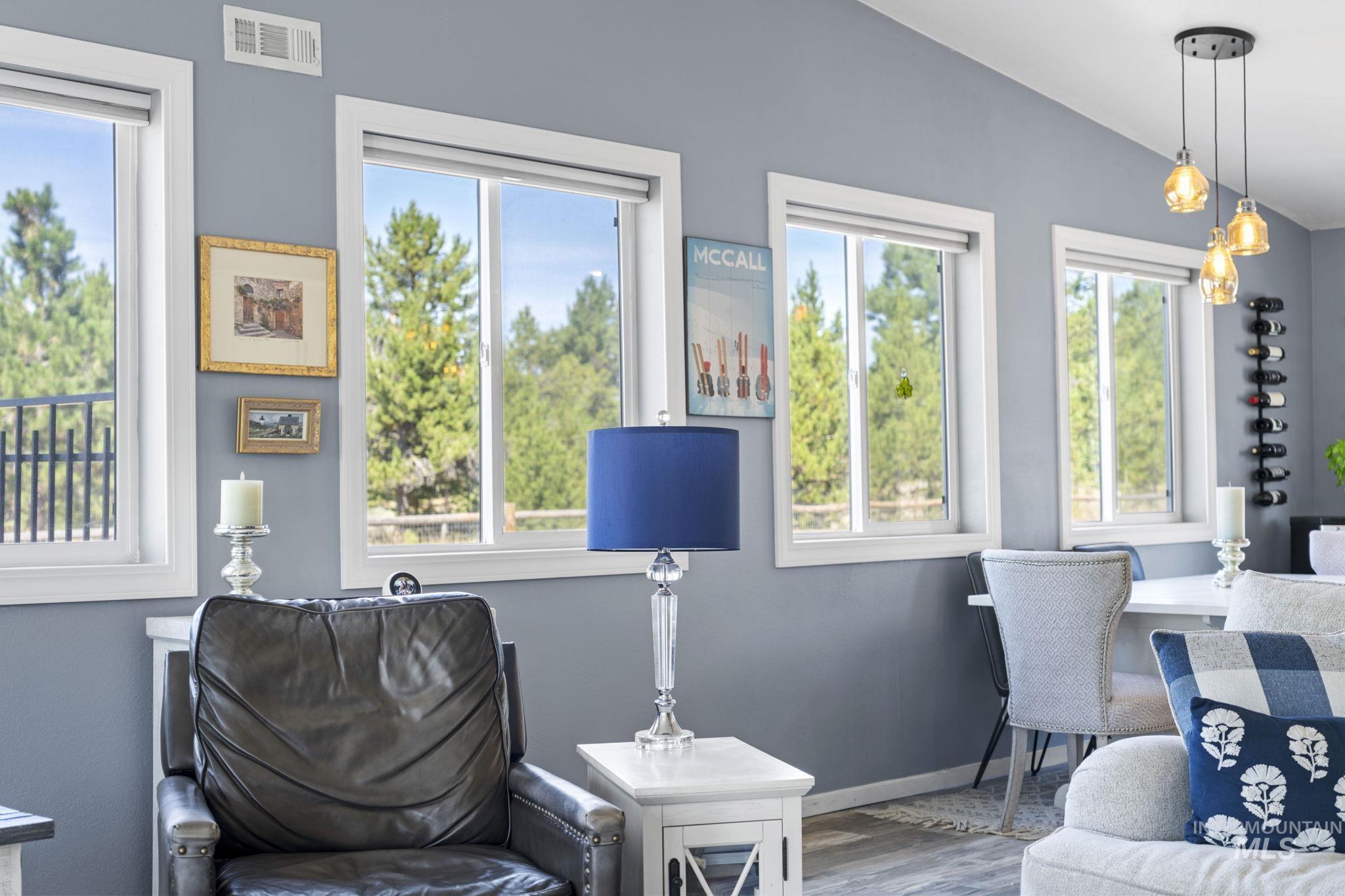 Living area featuring wood finished floors and vaulted ceiling