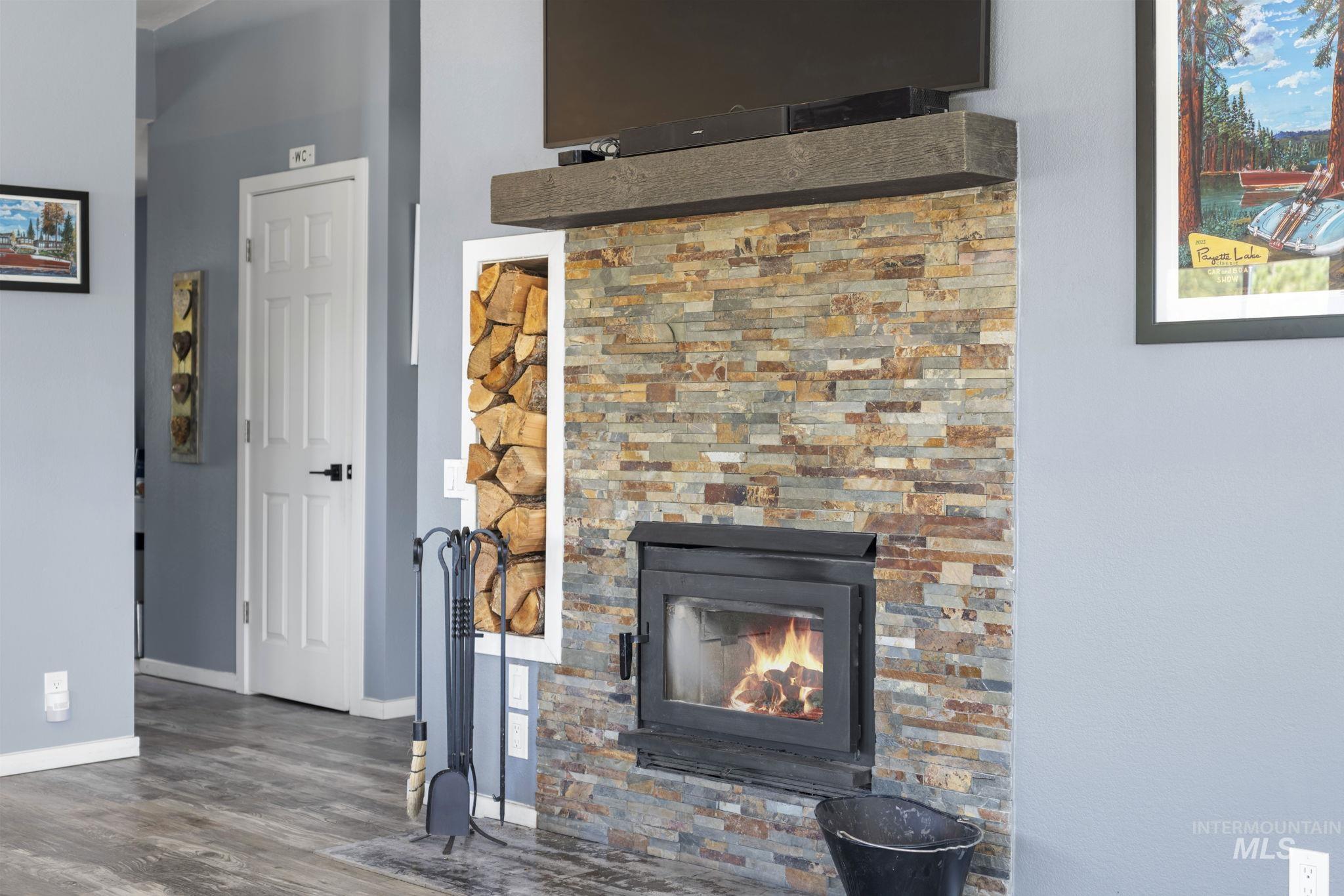 Detailed view of wood finished floors and a glass covered fireplace