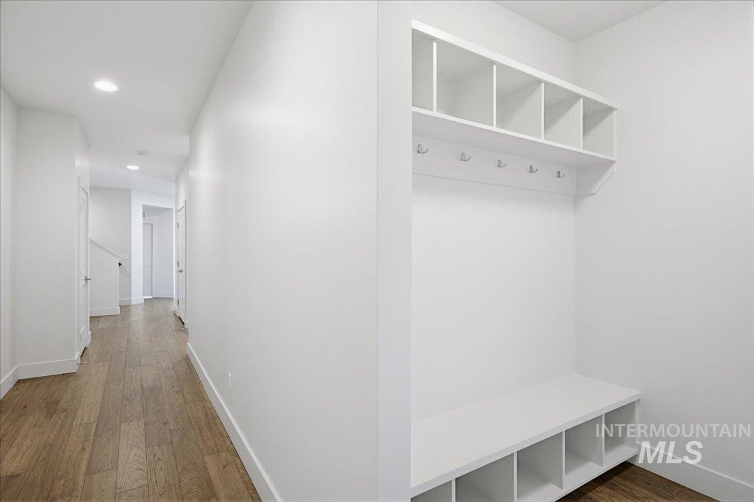 Entryway featuring a built-in bench with cubby storage, upper shelving, and coat hooks
