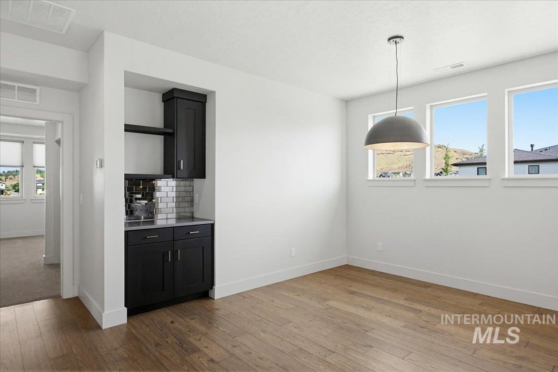 Bright interior with wood-finish flooring and a built-in beverage bar