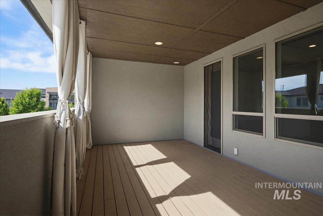 Private balcony featuring composite decking and recessed lighting