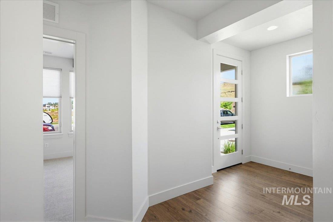 Entryway featuring a contemporary full-light door, wood-finish flooring, recessed lighting, and a transom window