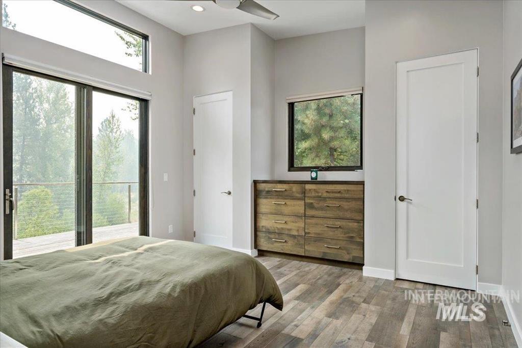 Bedroom featuring wood finished floors, access to outside, and recessed lighting