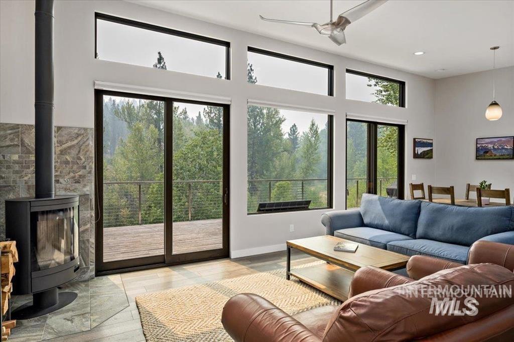 Living room featuring a wood stove, wood finished floors, and french doors