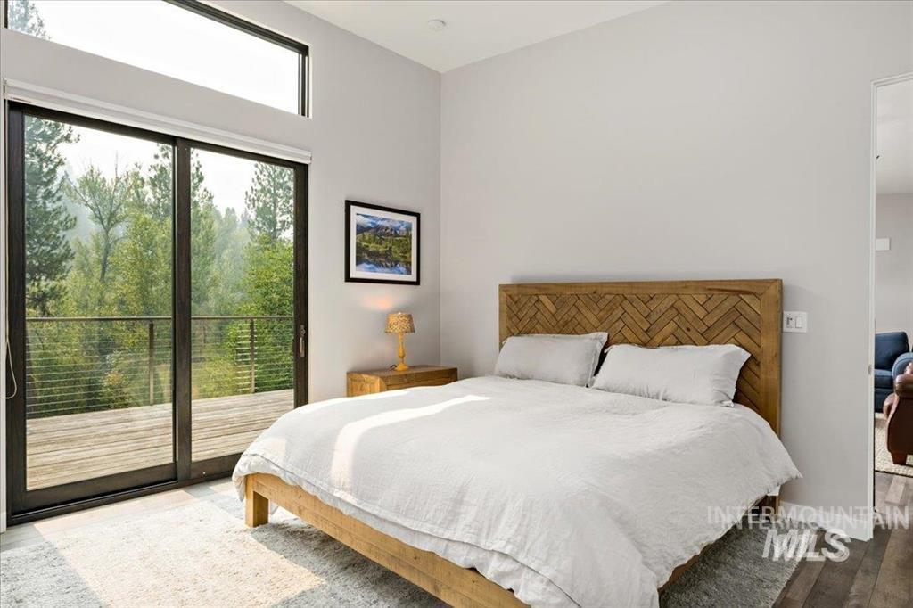 Bedroom featuring wood finished floors and access to exterior