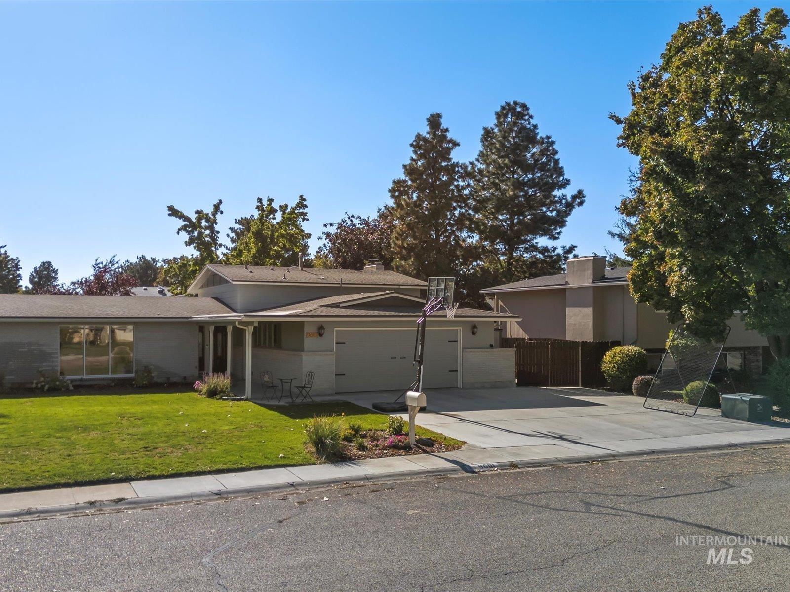 View of front of property with concrete driveway and a garage