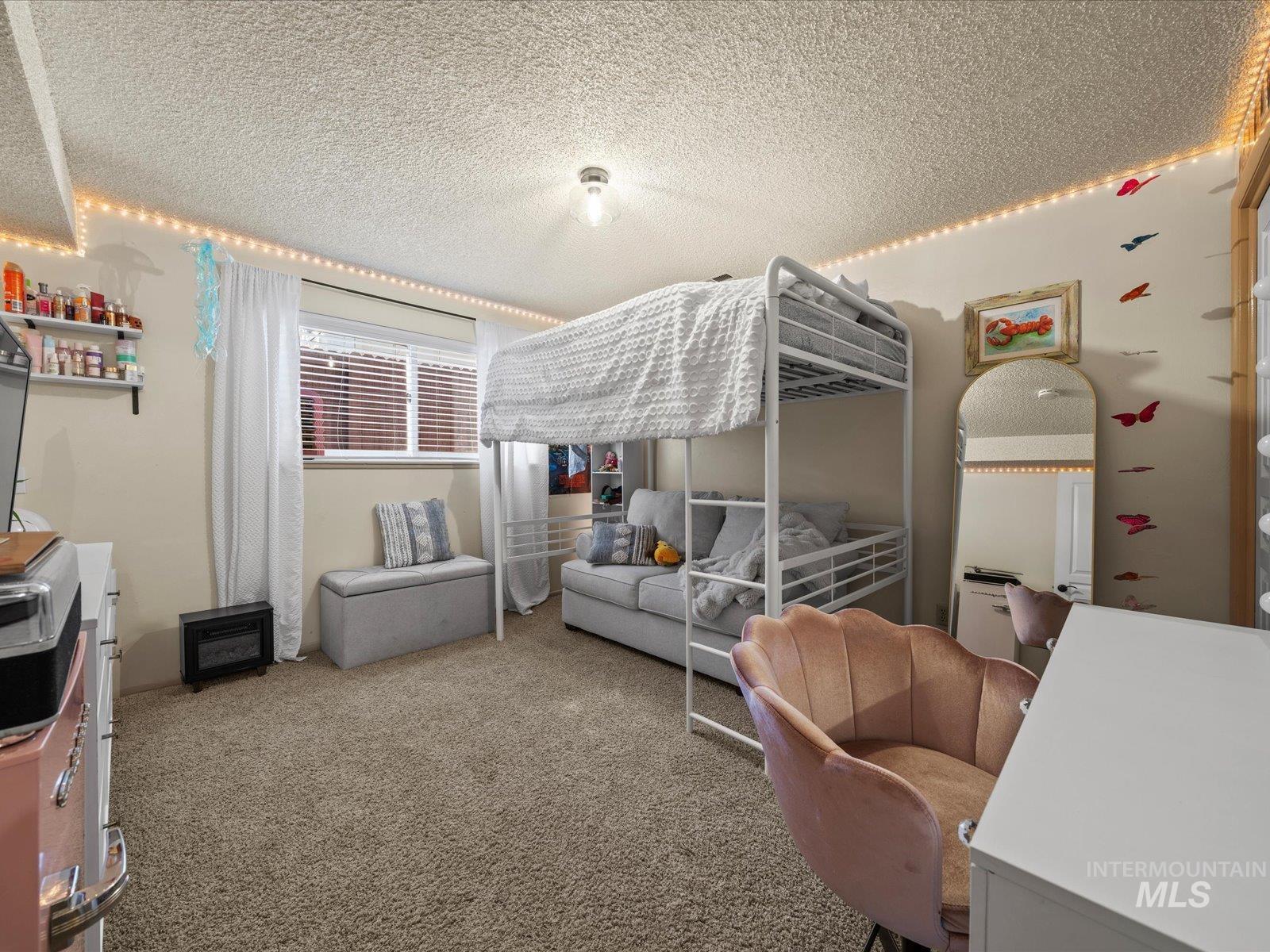 Bedroom with carpet flooring and a textured ceiling