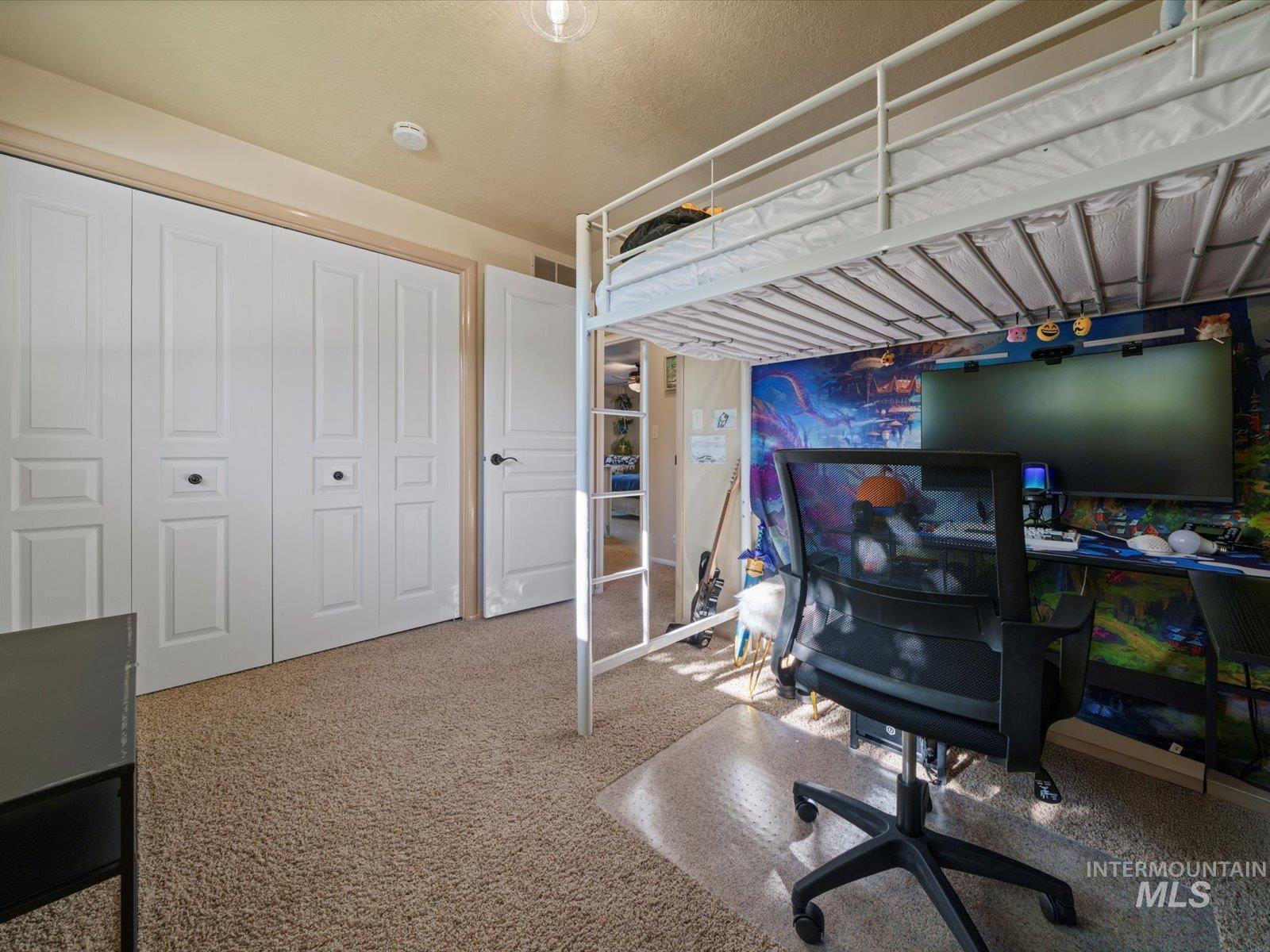 Carpeted bedroom featuring a closet