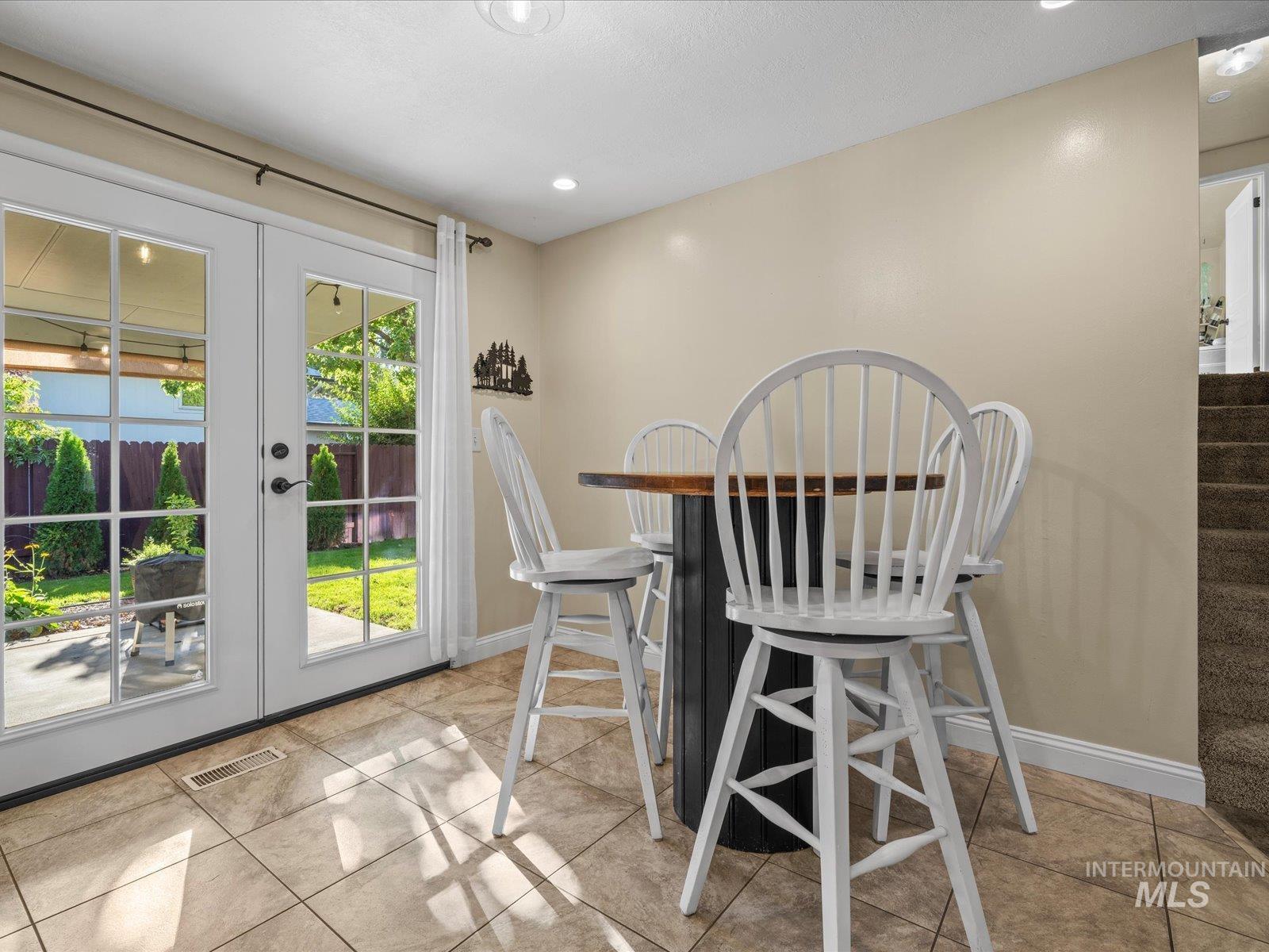 Dining room featuring french doors, stairs, recessed lighting, and light tile patterned floors