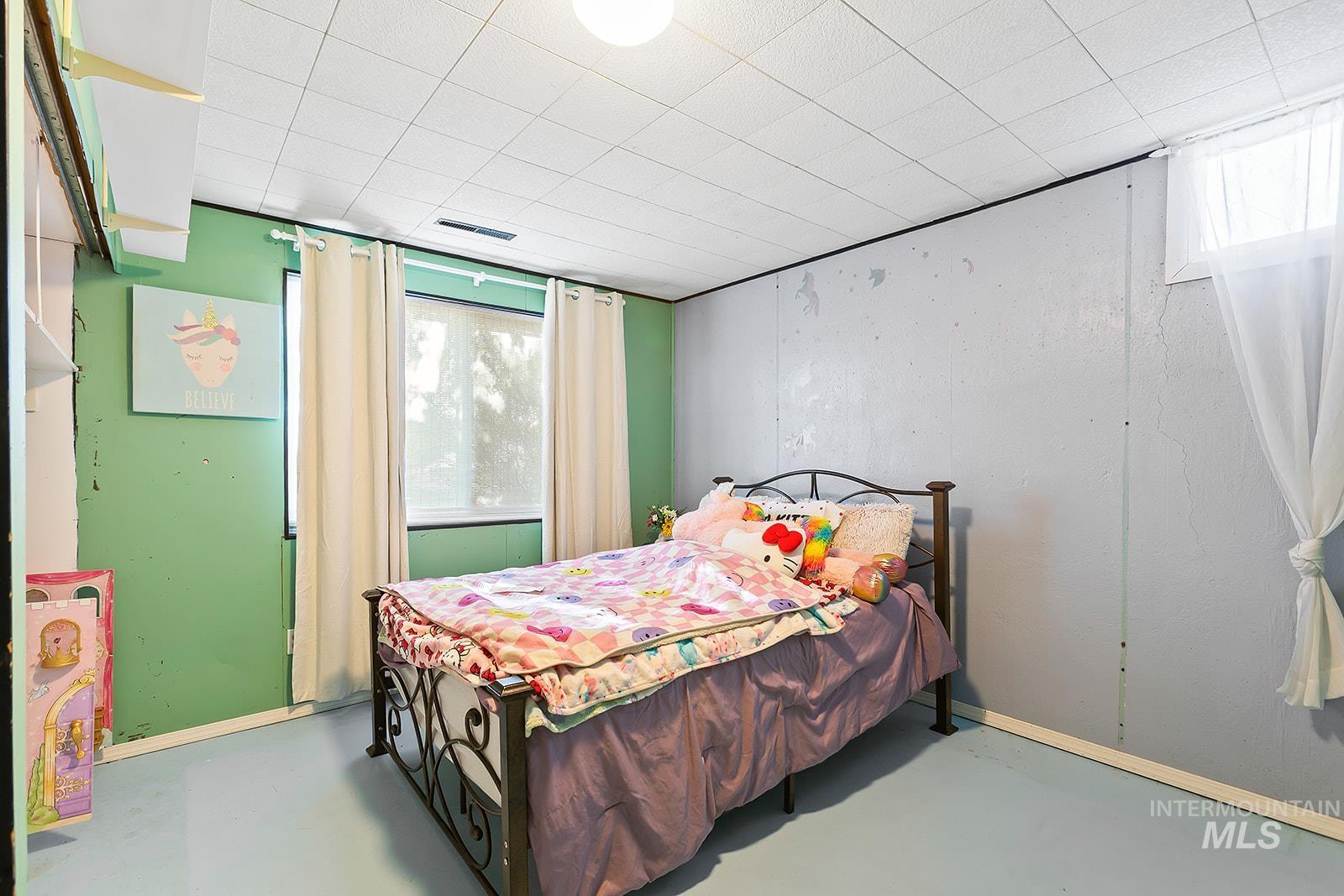Bedroom featuring concrete floors