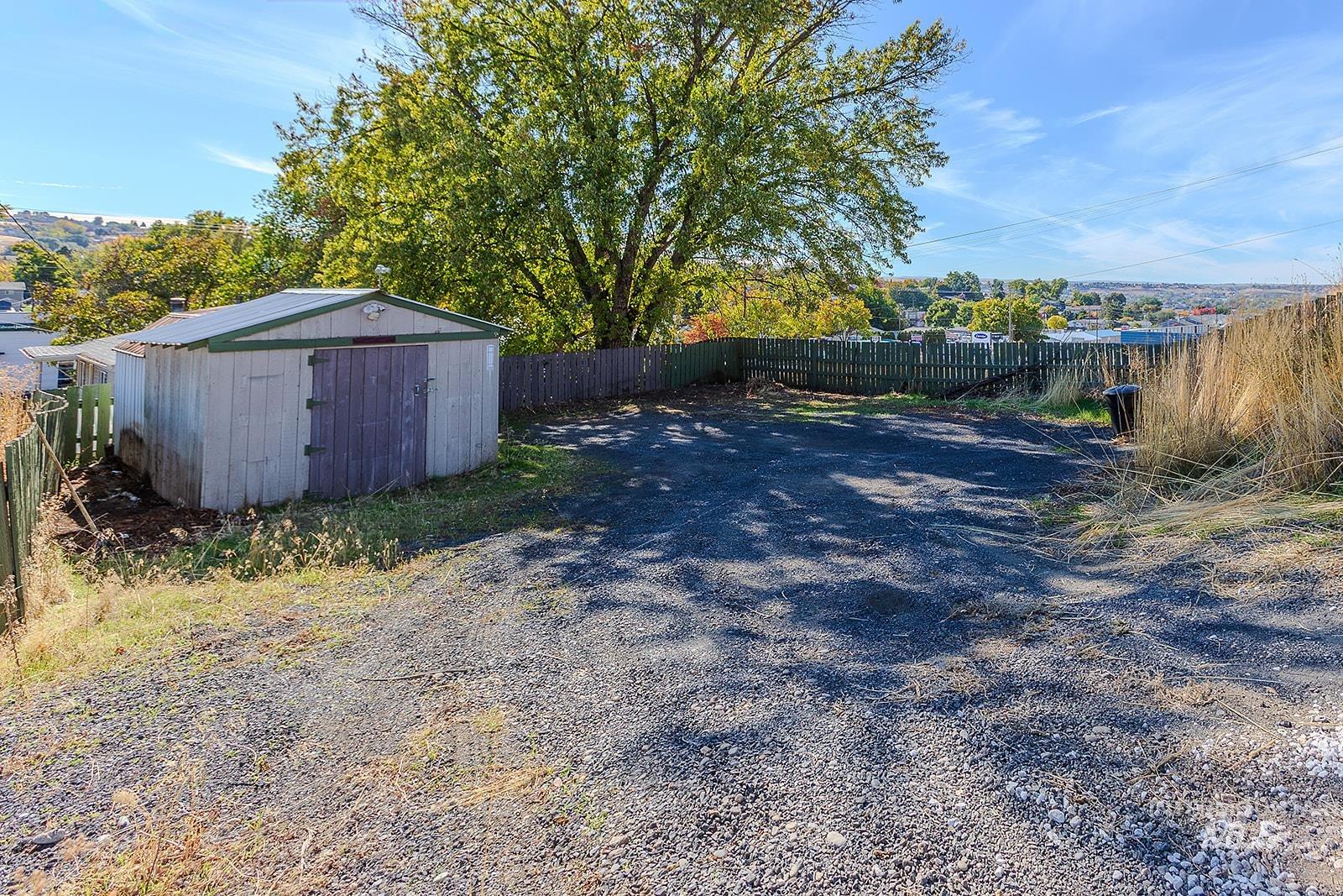 Fenced backyard with a shed