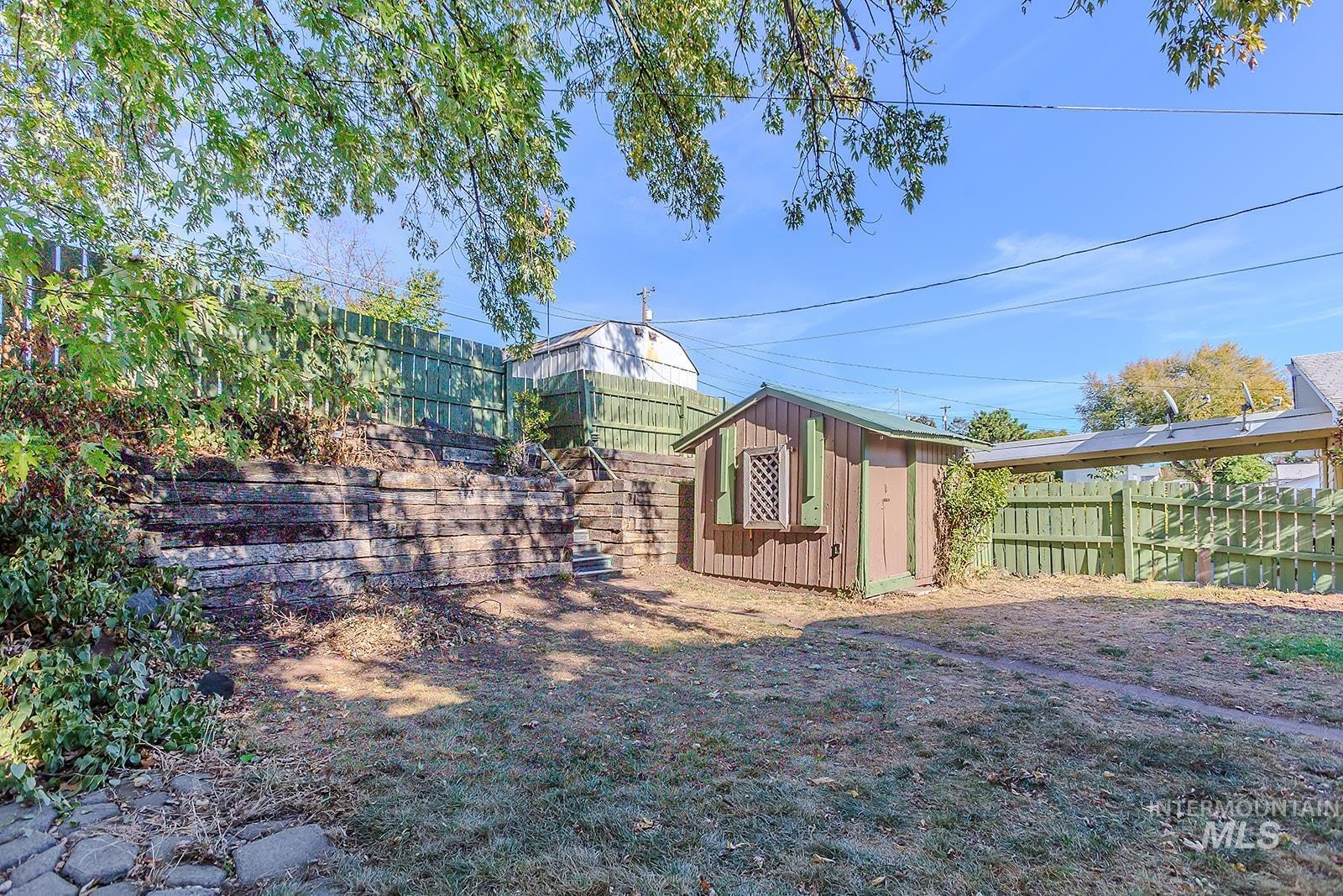 Fenced backyard with a storage unit