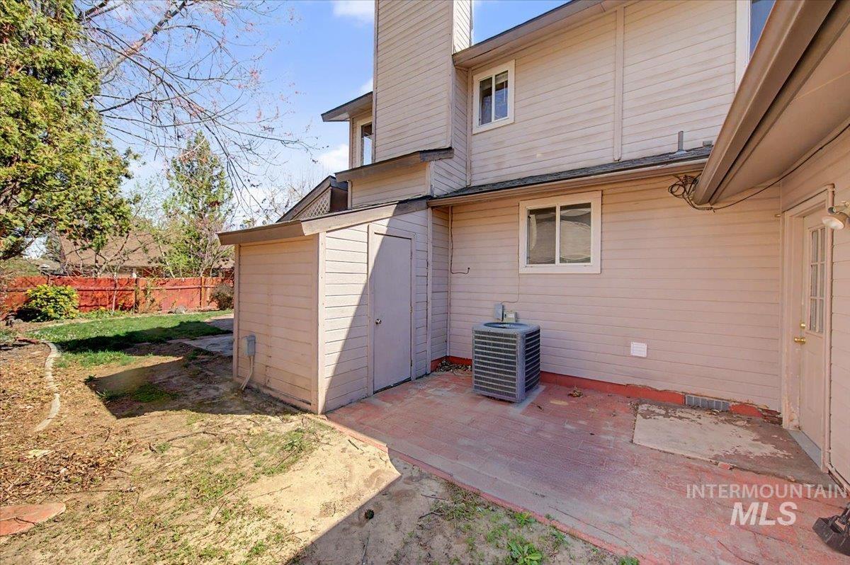 Rear view of house featuring a patio, a chimney, and crawl space