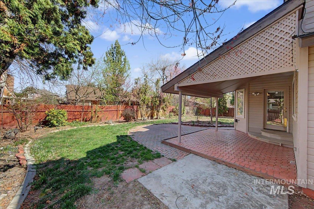 Fenced backyard with a patio