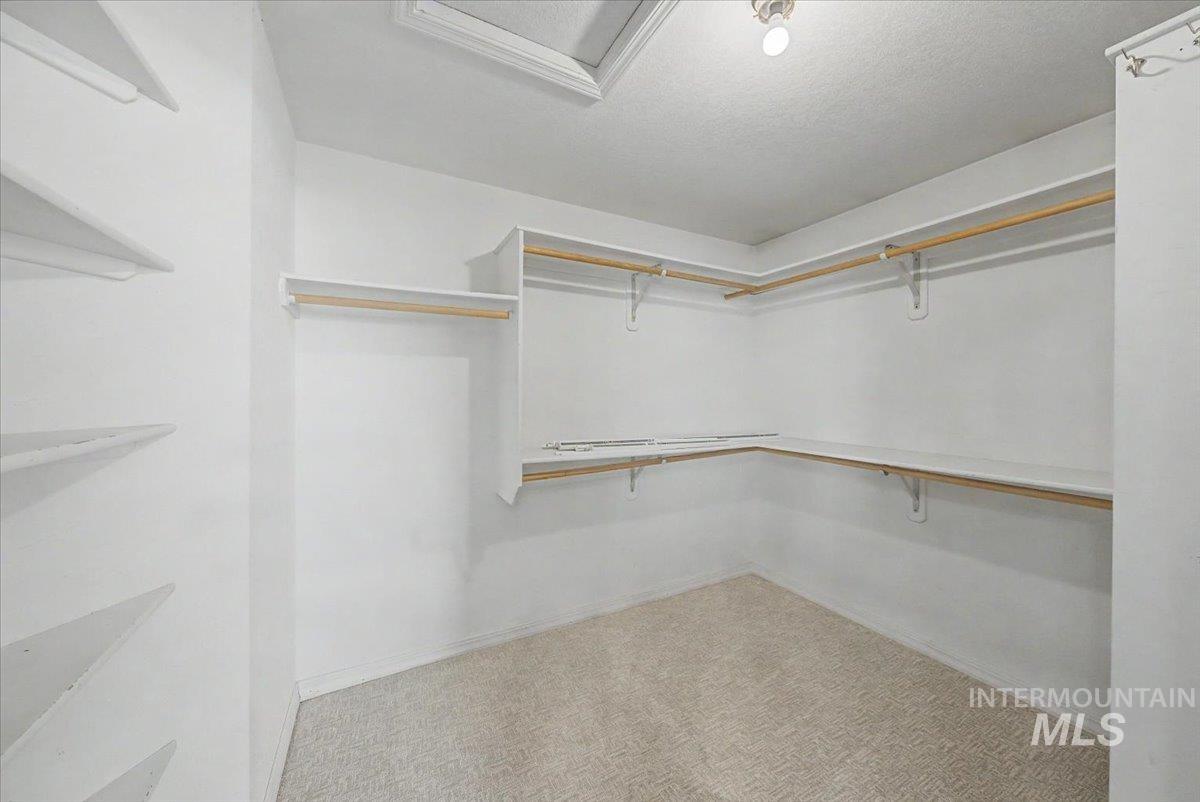 Walk in closet featuring attic access