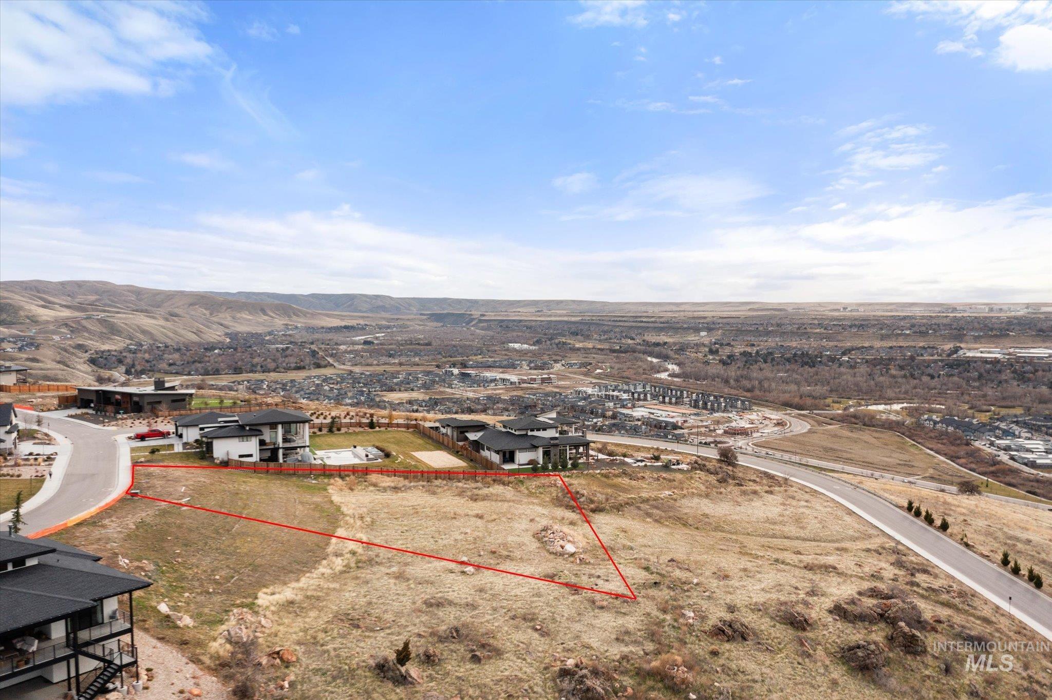 Aerial view of property and surrounding area featuring property boundaries highlighted and mountains